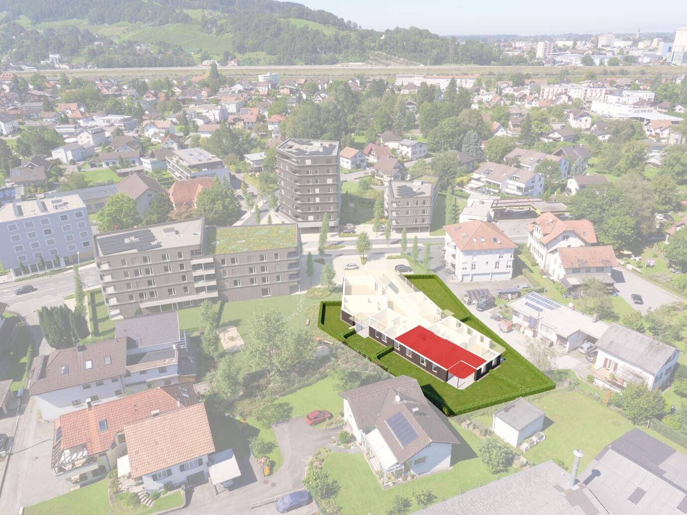 Luftbild einer Wohnsiedlung mit einem hervorgehobenen, rot markierten Gebäudeentwurf auf einer grünen Rasenfläche (Rheindorf).