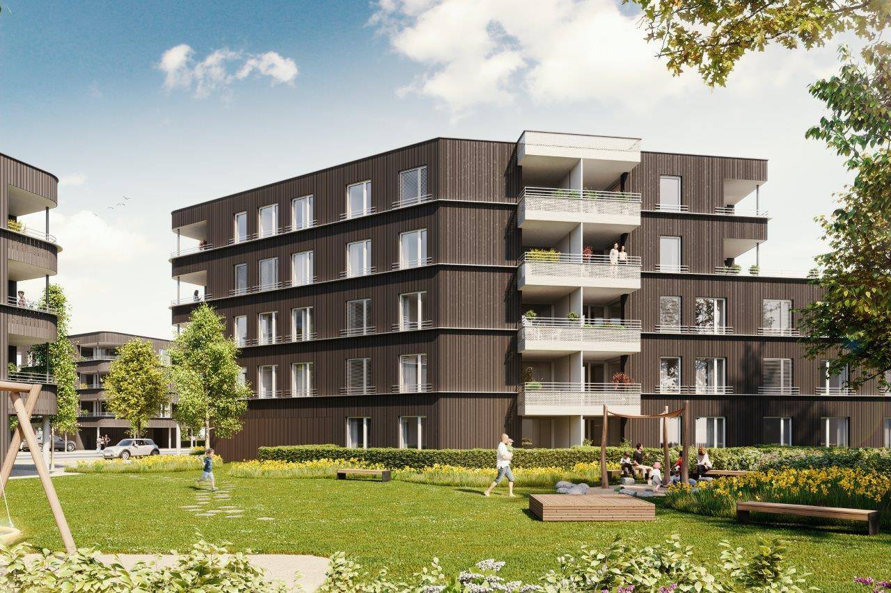 Großzügige Grünfläche mit Spielplatz und Sitzgelegenheiten vor einem modernen Wohngebäude.