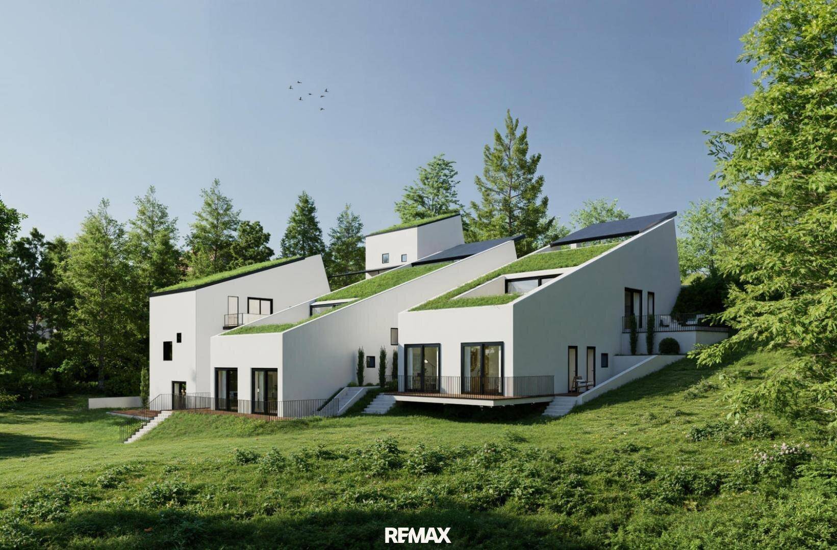 Zeitgenössische Architektur mit begrünten Dächern, großen Fenstern und harmonischer Integration in die Natur.