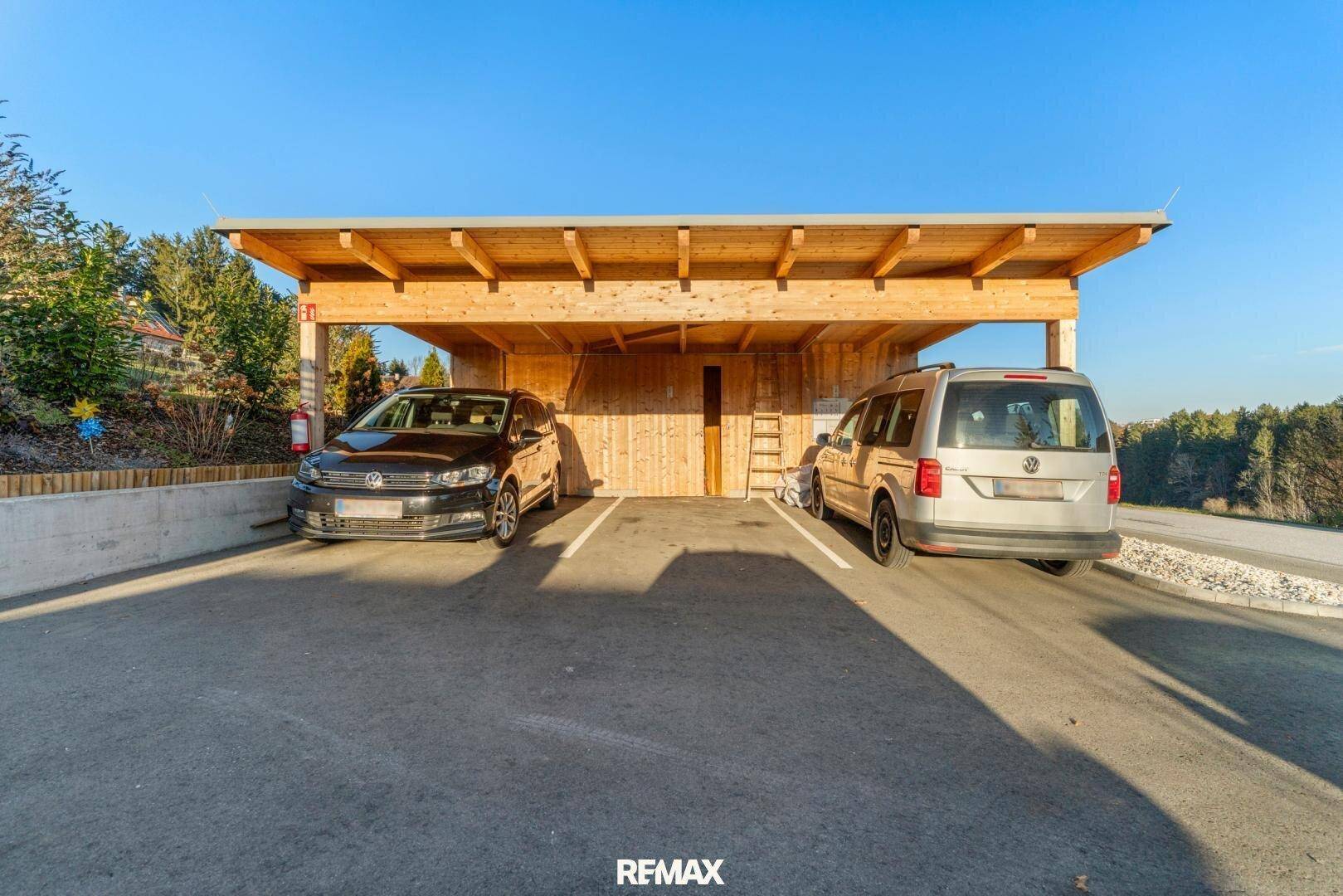 Geräumiger Holzcarport mit zwei Stellplätzen für Fahrzeuge.