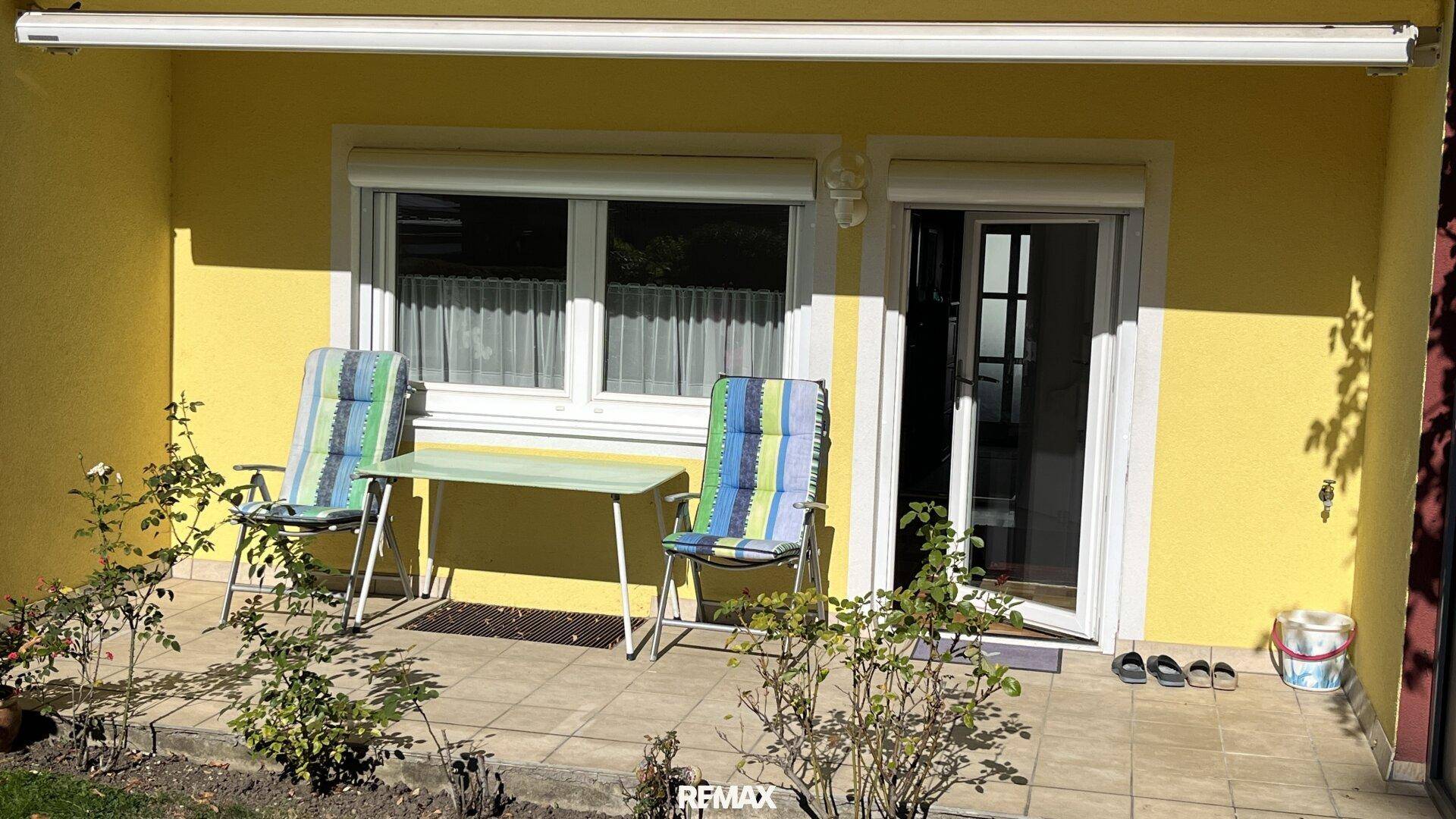 Gemütliche Terrasse mit Markise, Gartenmöbeln und direktem Zugang zum Haus.