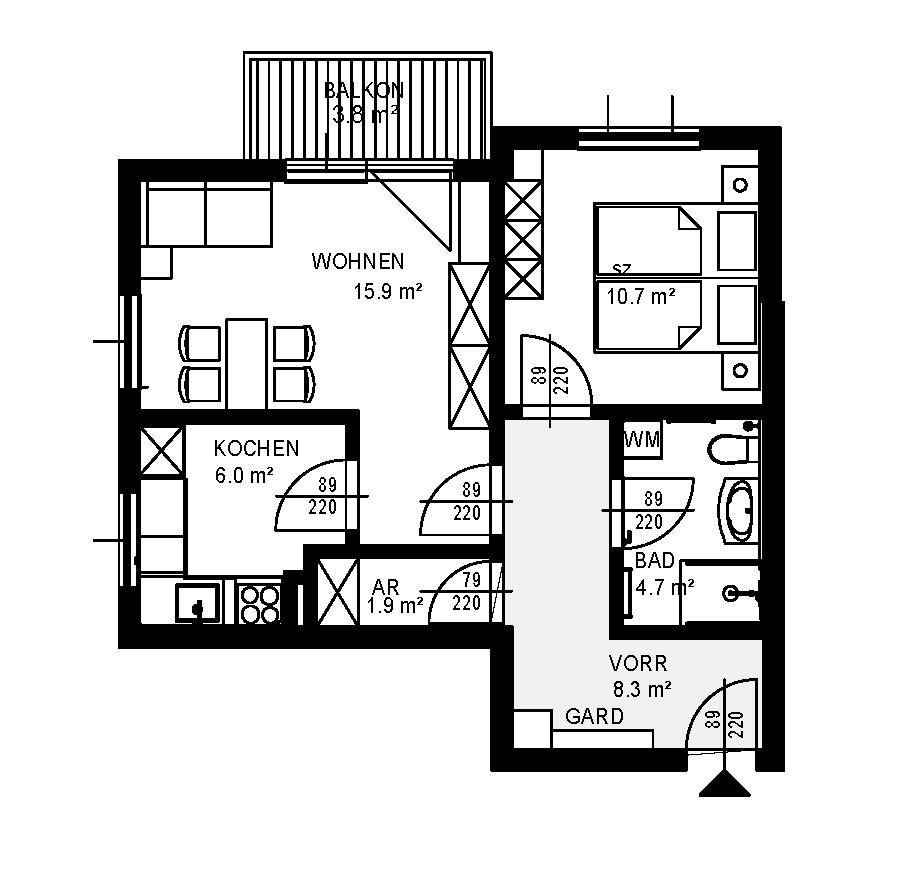 Grundriss einer Wohnung mit Balkon, Wohnbereich, Küche und Schlafzimmer.