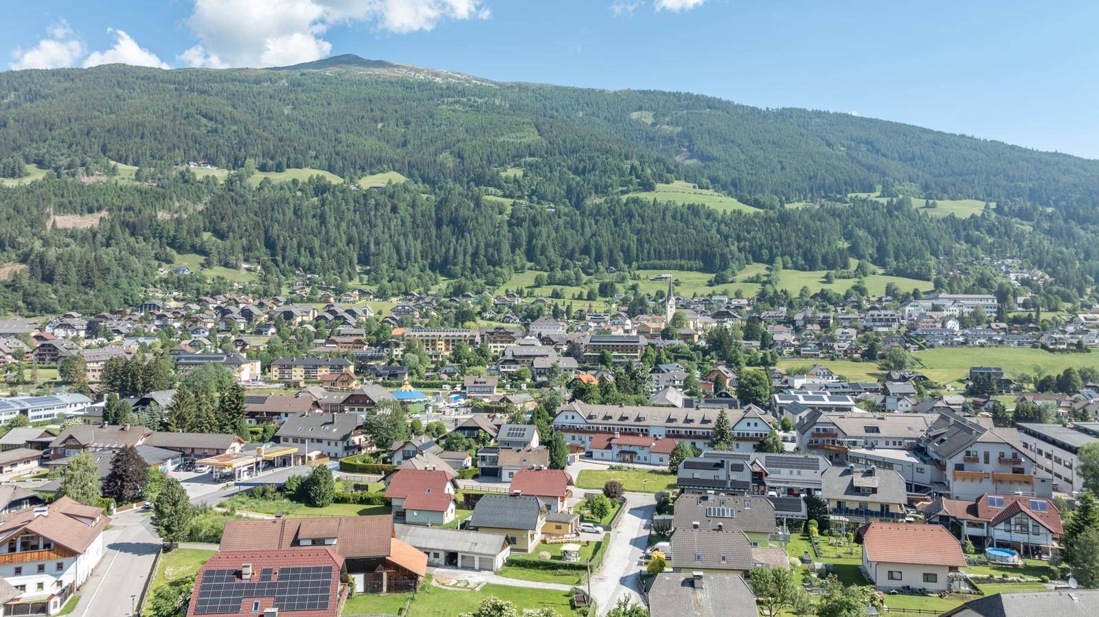 Panoramablick auf die malerische Berglandschaft und das Dorf mit vielen Häusern.