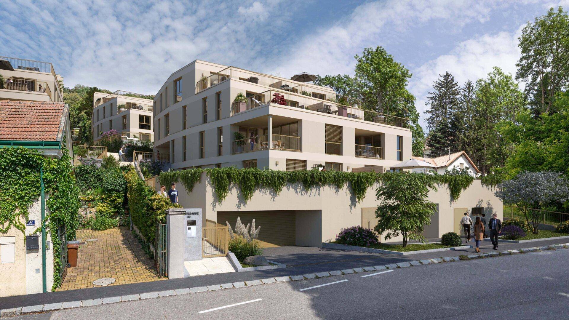 Ansicht des modernen Wohnkomplexes von der Straße mit Tiefgaragenzufahrt und Eingangsbereich.