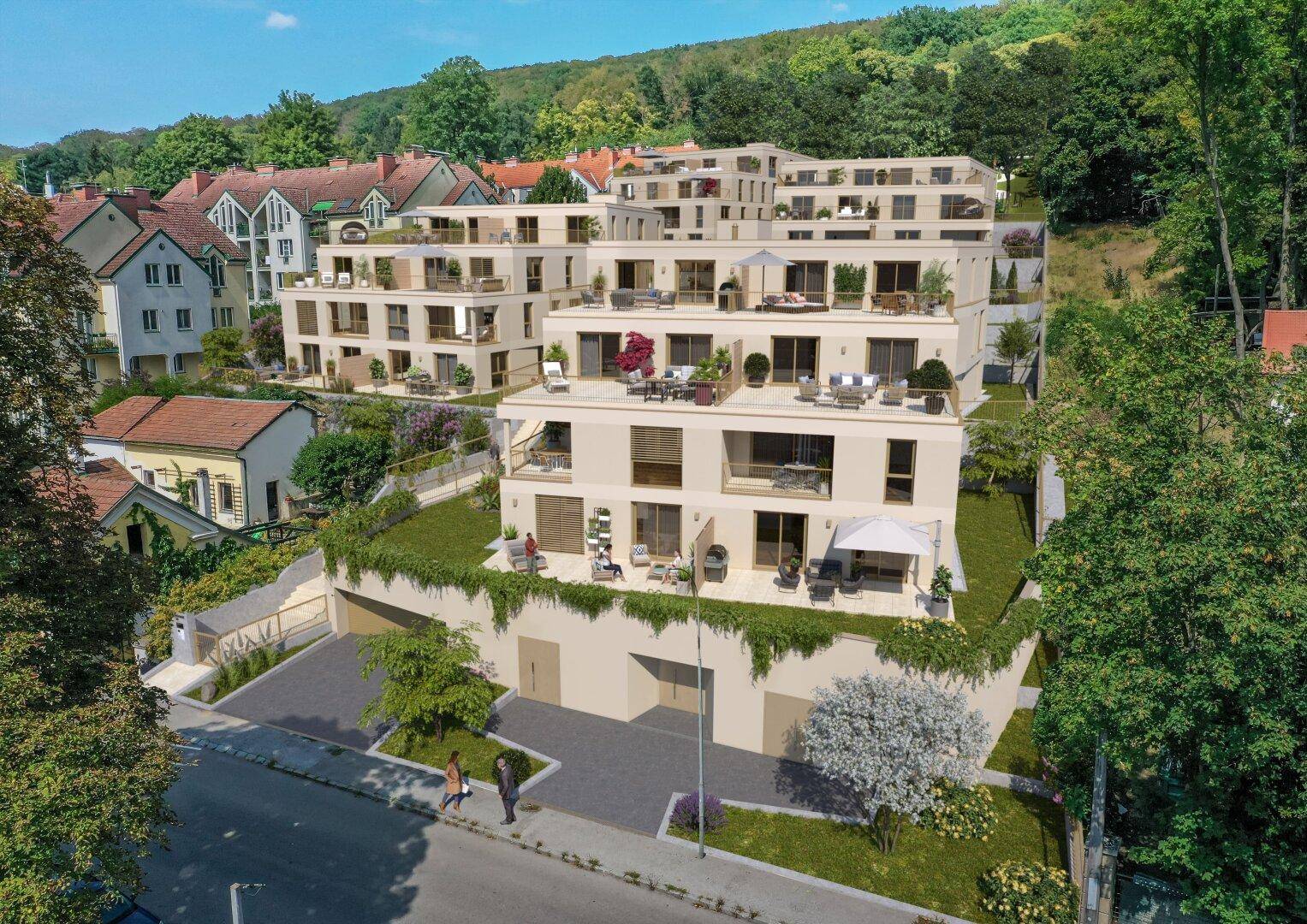 Gesamtansicht der modernen Wohnanlage mit Terrassen und viel Grün in Hanglage.
