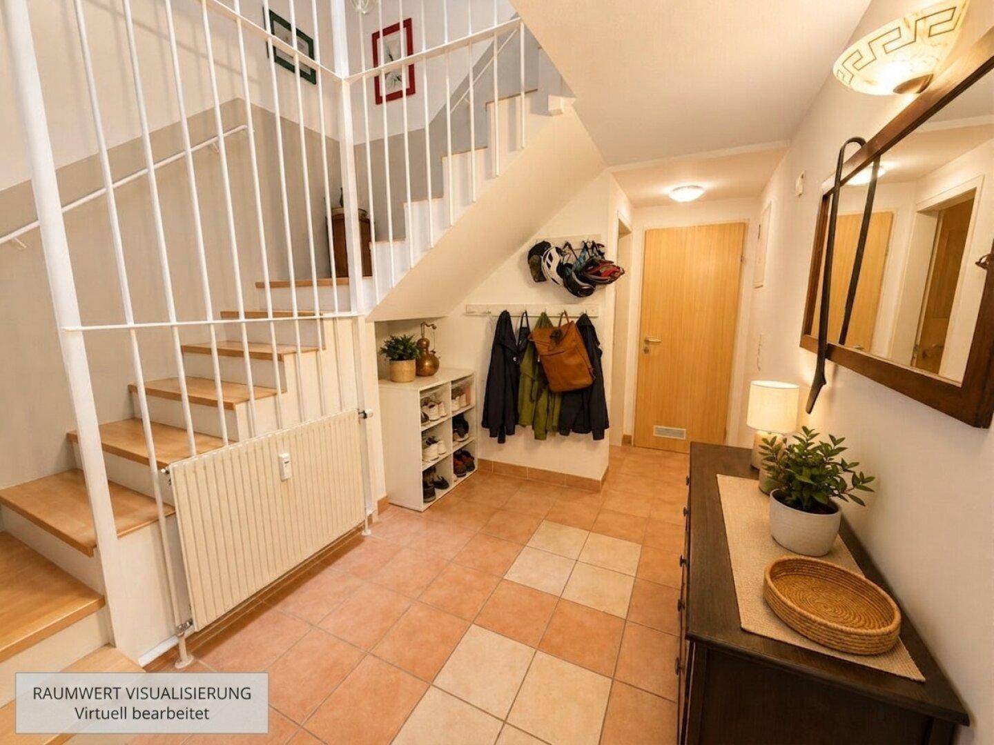 Heller Eingangsbereich mit Treppe, Fliesenboden und praktischer Garderobe für Schuhe und Jacken.