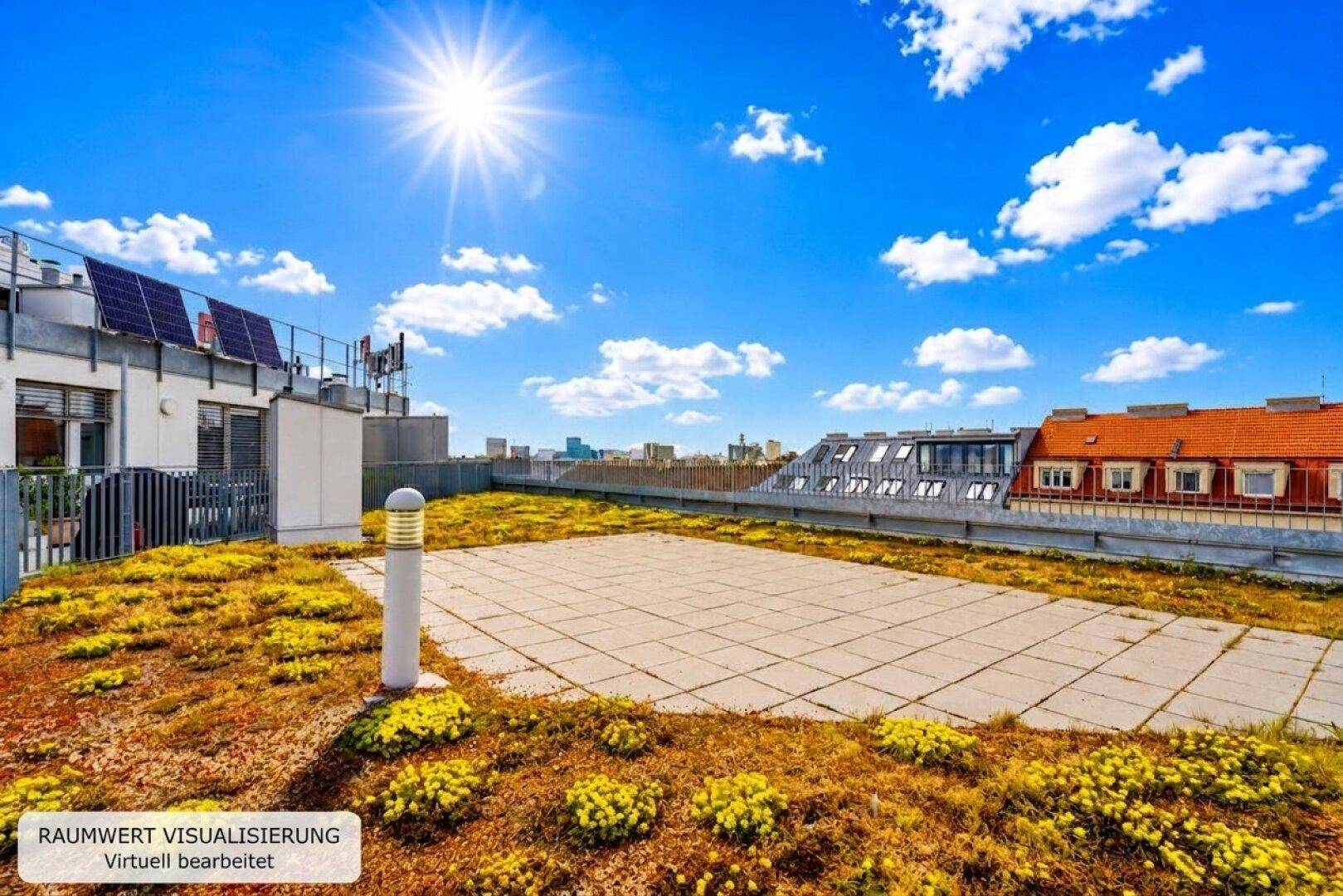 Grüne Dachfläche mit gepflastertem Bereich und Solarmodulen unter blauem Himmel.