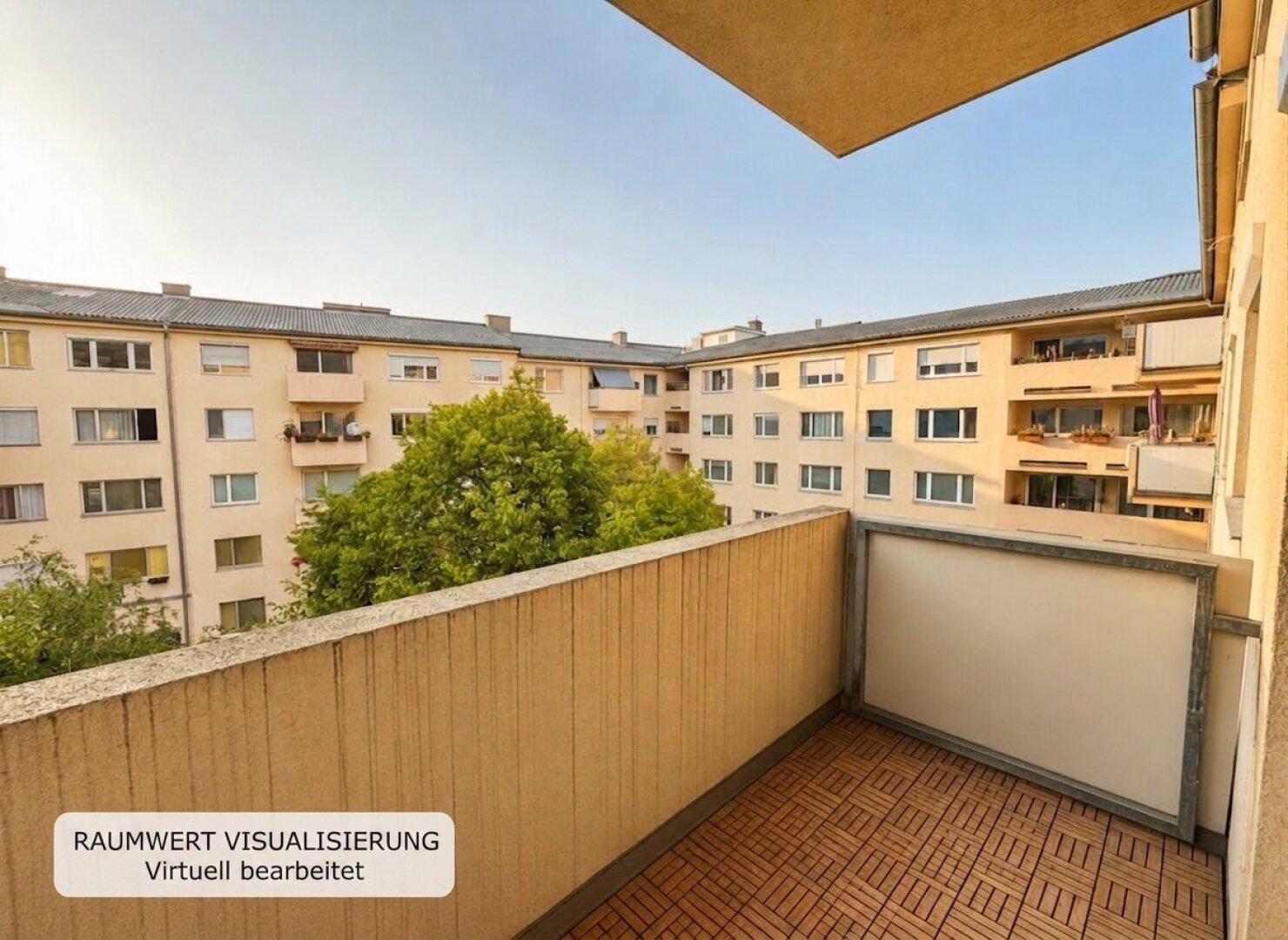 Balkon mit Holzbodenfliesen und Blick auf die umliegenden Wohngebäude und Bäume.