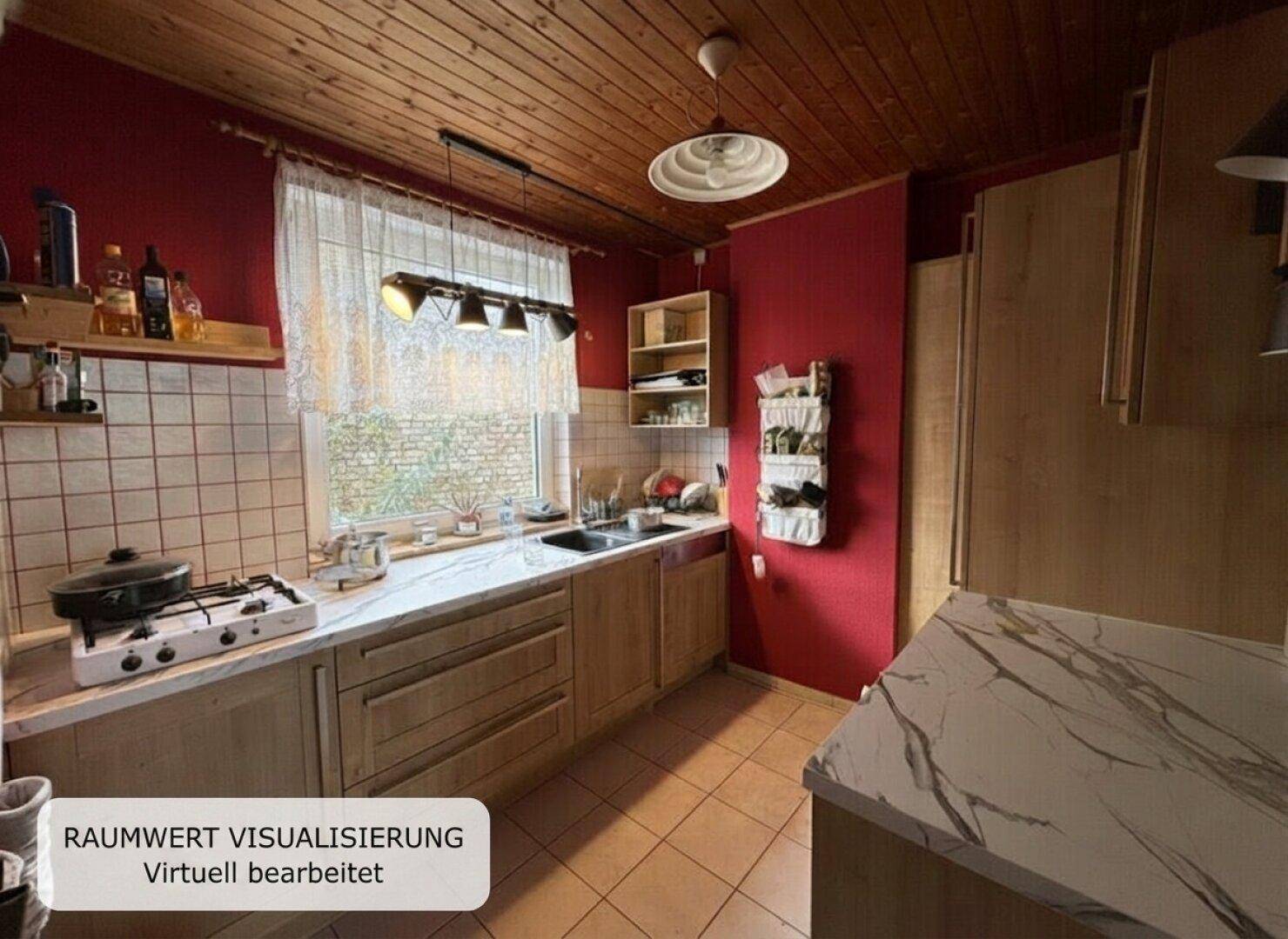 Gemütliche Küche mit roten Wänden, Holzdecke und funktionaler Ausstattung, ideal für kulinarische Aktivitäten.
