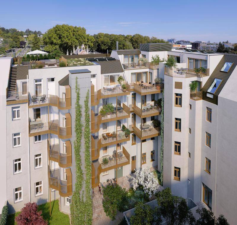 Moderne Gebäudefassade mit zahlreichen Balkonen, begrünten Wänden und einem Innenhof.