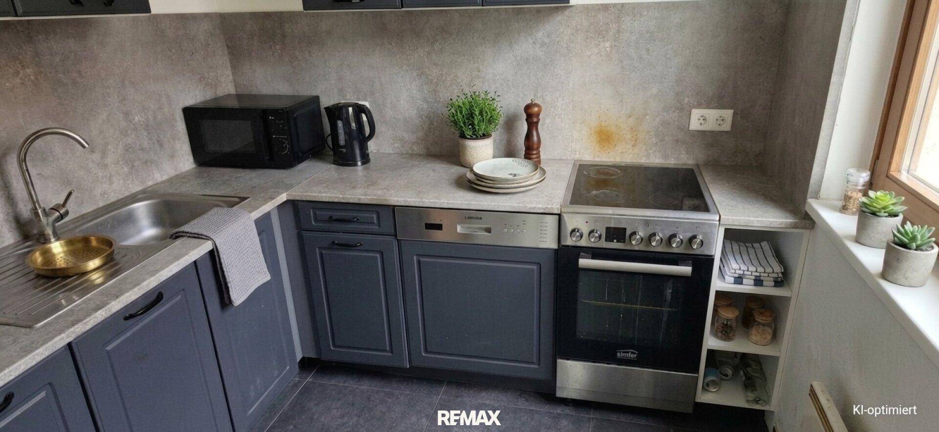 Moderne Küche mit grauen Schränken, Spülmaschine, Backofen und Mikrowelle, gut ausgestattet und funktional.