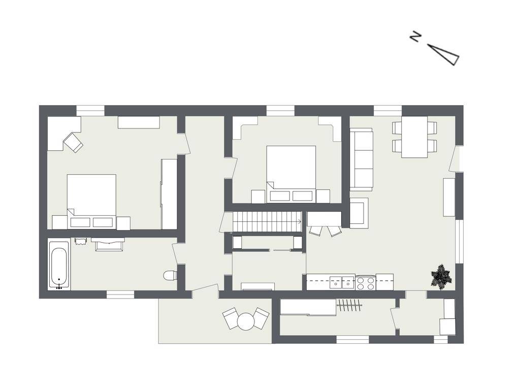 Grundriss einer Etage mit Aufteilung in Schlafzimmer, Bad und Wohnbereich.