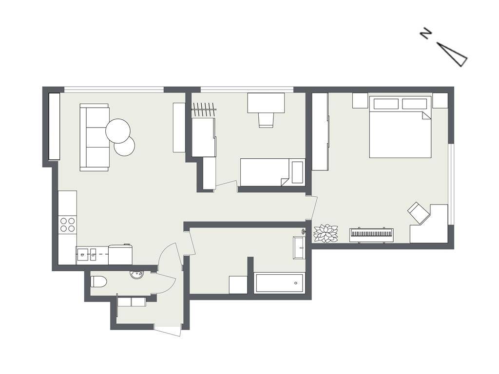 Grundriss einer Wohnung mit offenem Wohn- und Küchenbereich, einem Schlafzimmer, einem weiteren Zimmer und separatem WC.