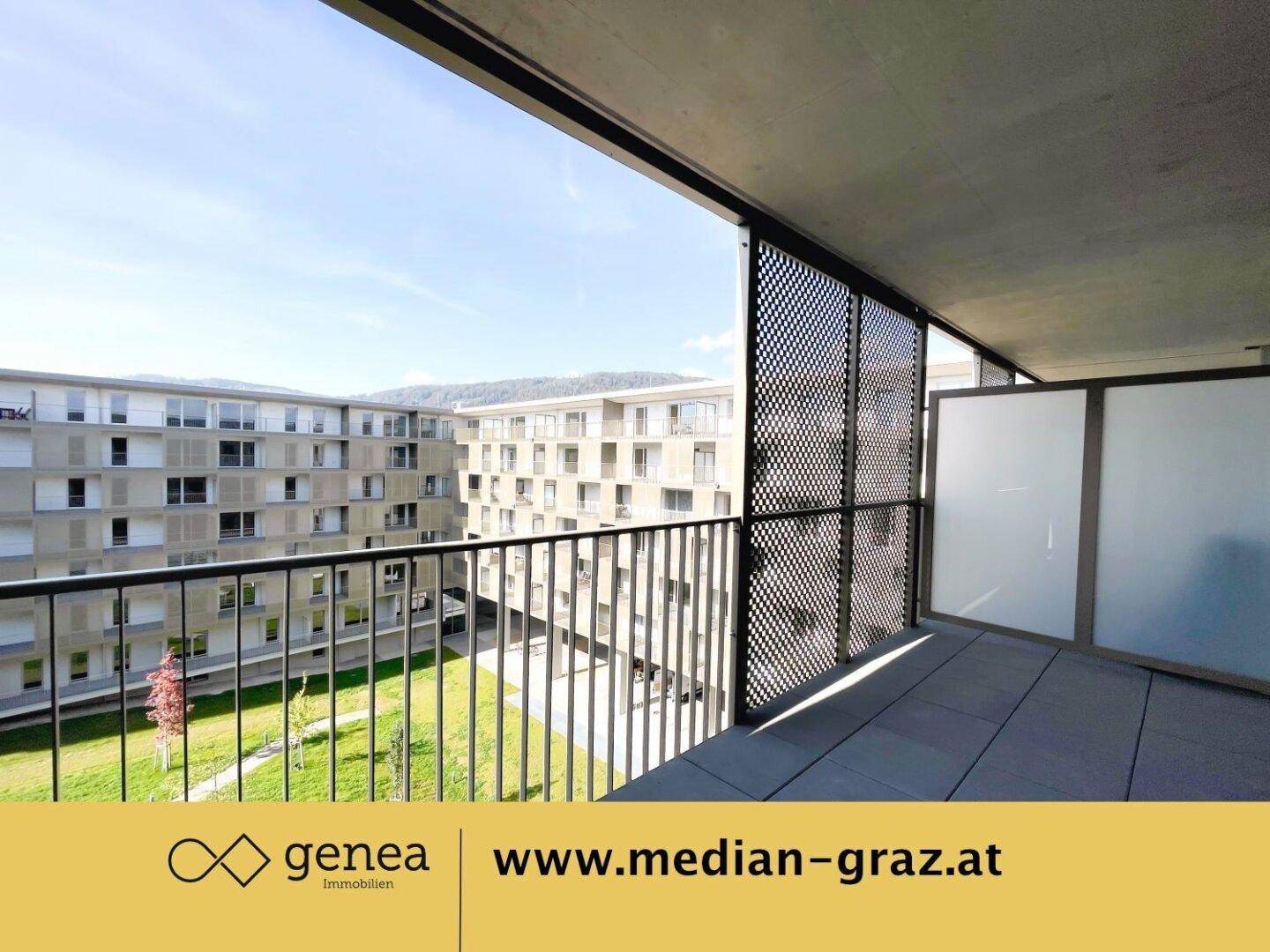 Geräumiger Balkon mit Metallgeländer und Sichtschutz, mit Blick auf den Innenhof.