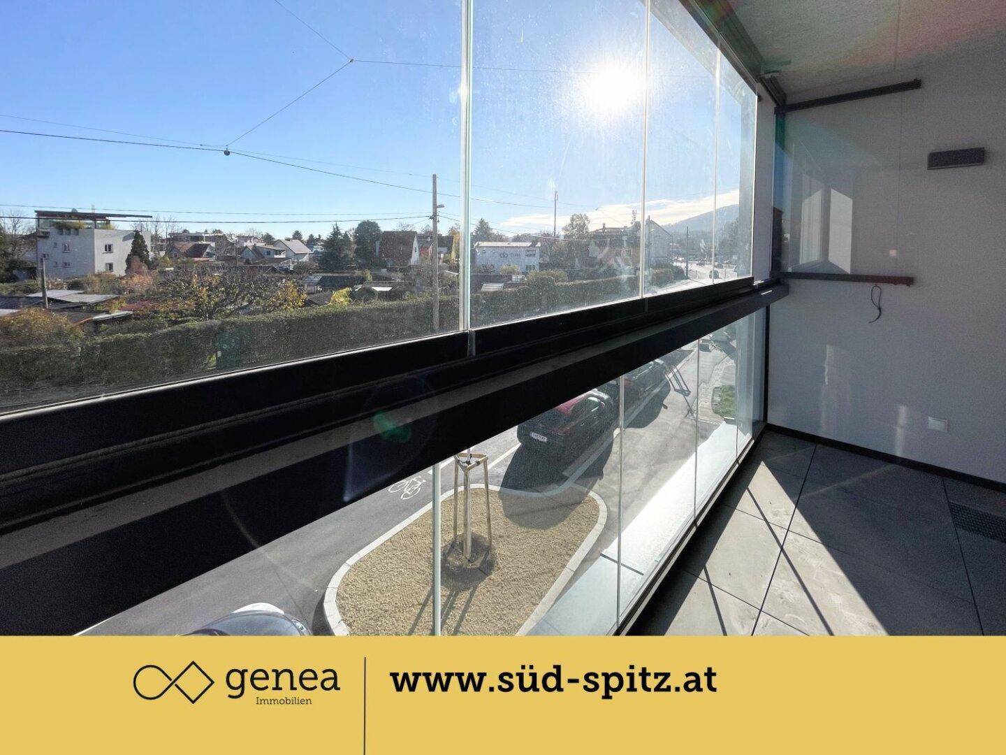 Verglaste Loggia mit Blick auf die Straße und die umliegende Wohngegend.