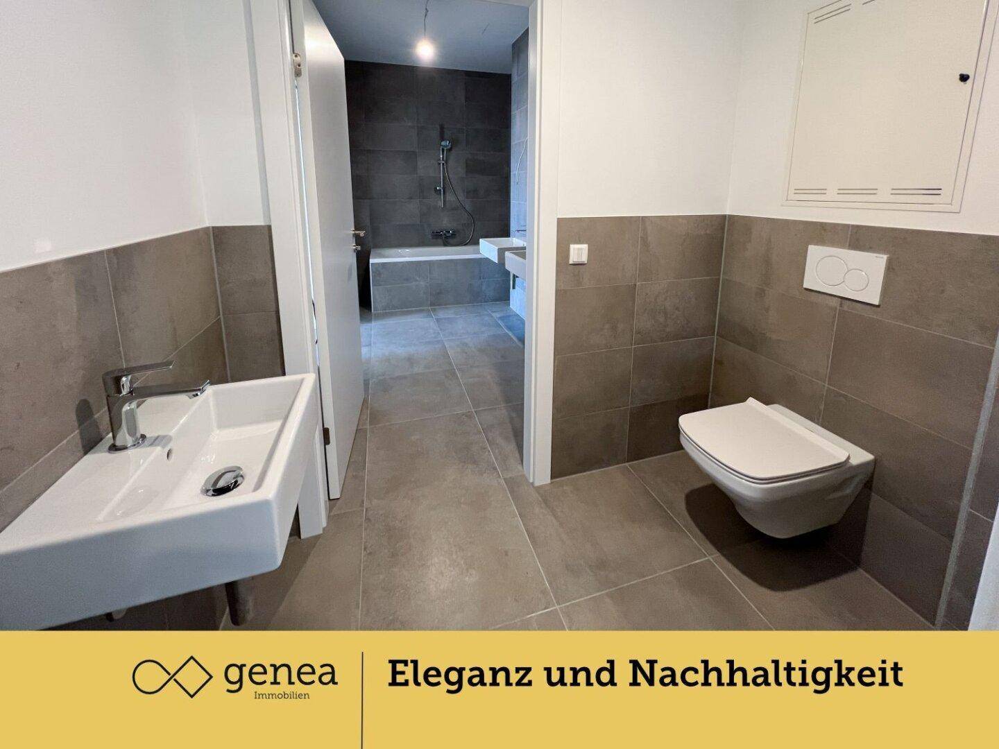 Modernes Badezimmer mit Wand-WC, Einzelwaschbecken und grauen Fliesen.