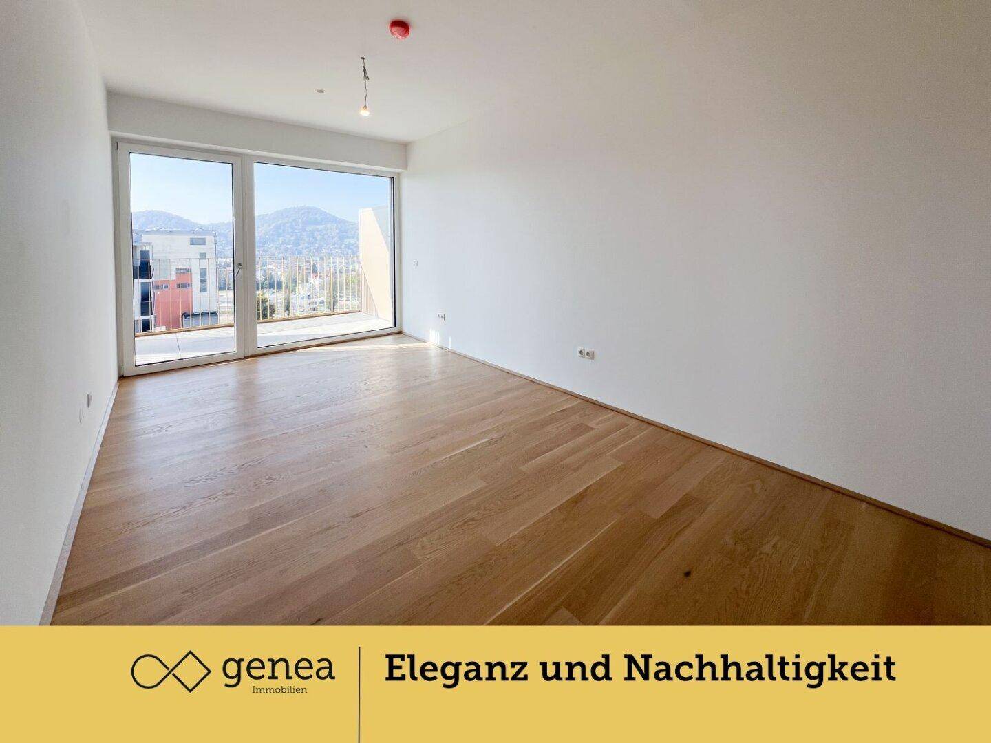Heller Raum mit Parkettboden und Zugang zu einem Balkon mit Bergblick.