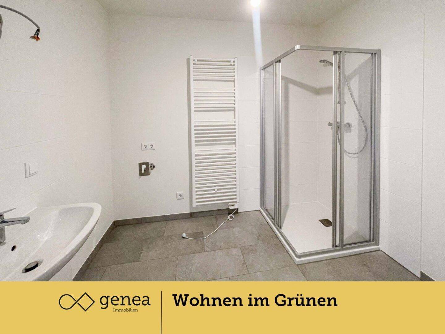 Modernes Badezimmer mit Duschkabine, Waschbecken und beheiztem Handtuchhalter.