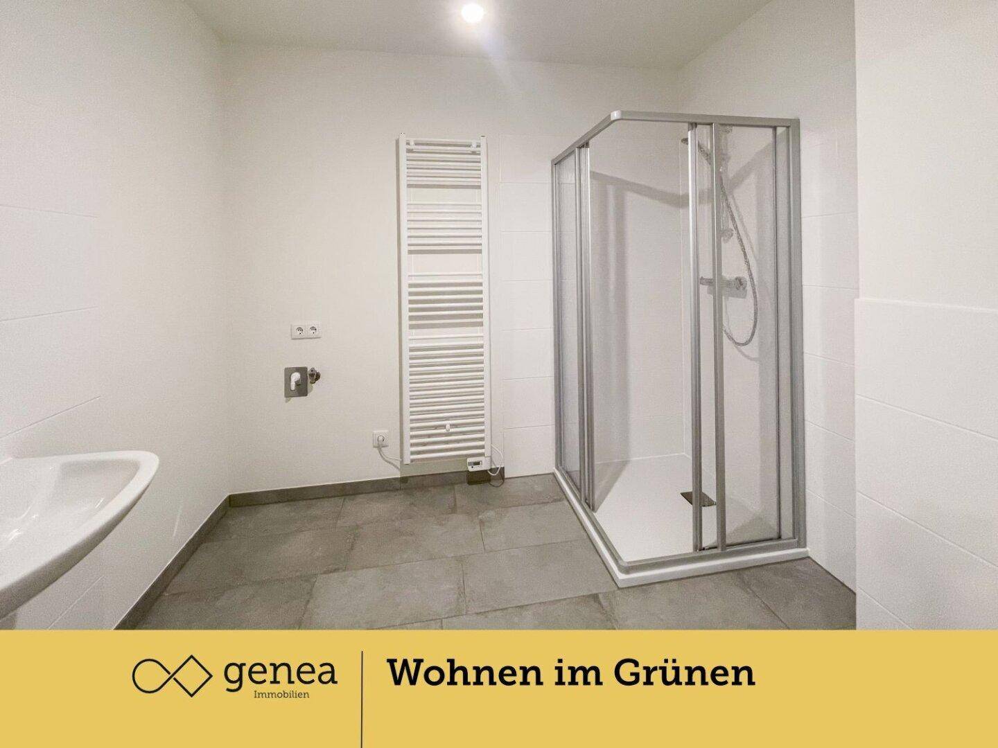 Modernes Badezimmer mit Duschkabine, Waschbecken und beheiztem Handtuchhalter.