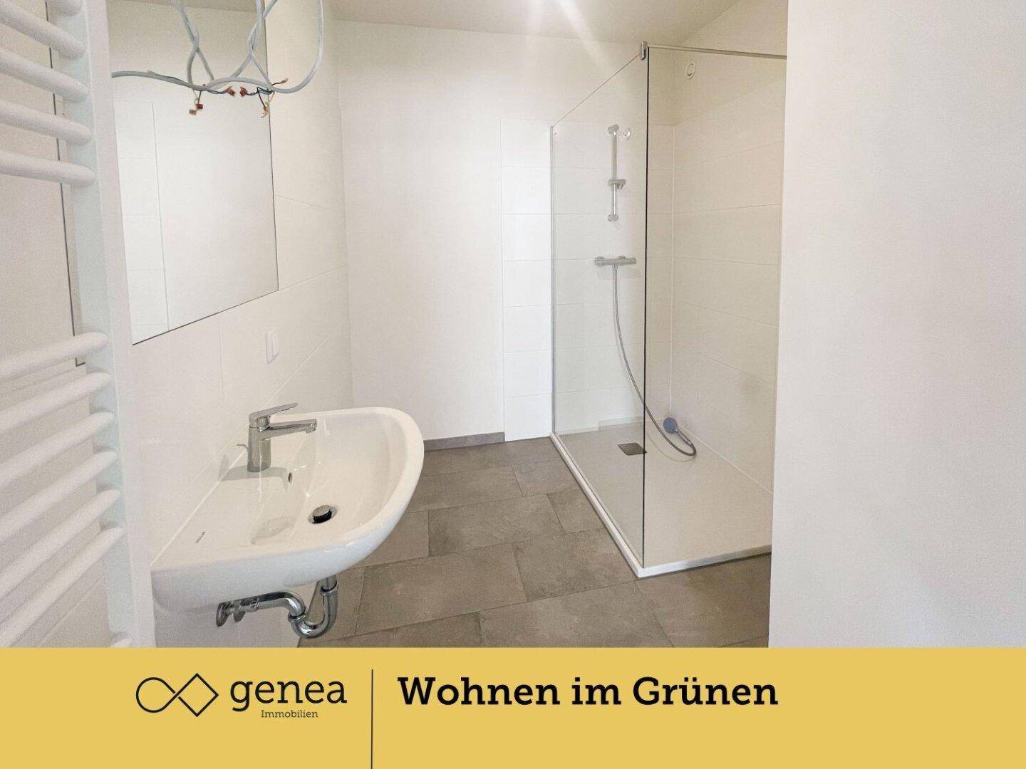 Modernes Badezimmer mit ebenerdiger Dusche, Waschbecken und beheiztem Handtuchhalter.