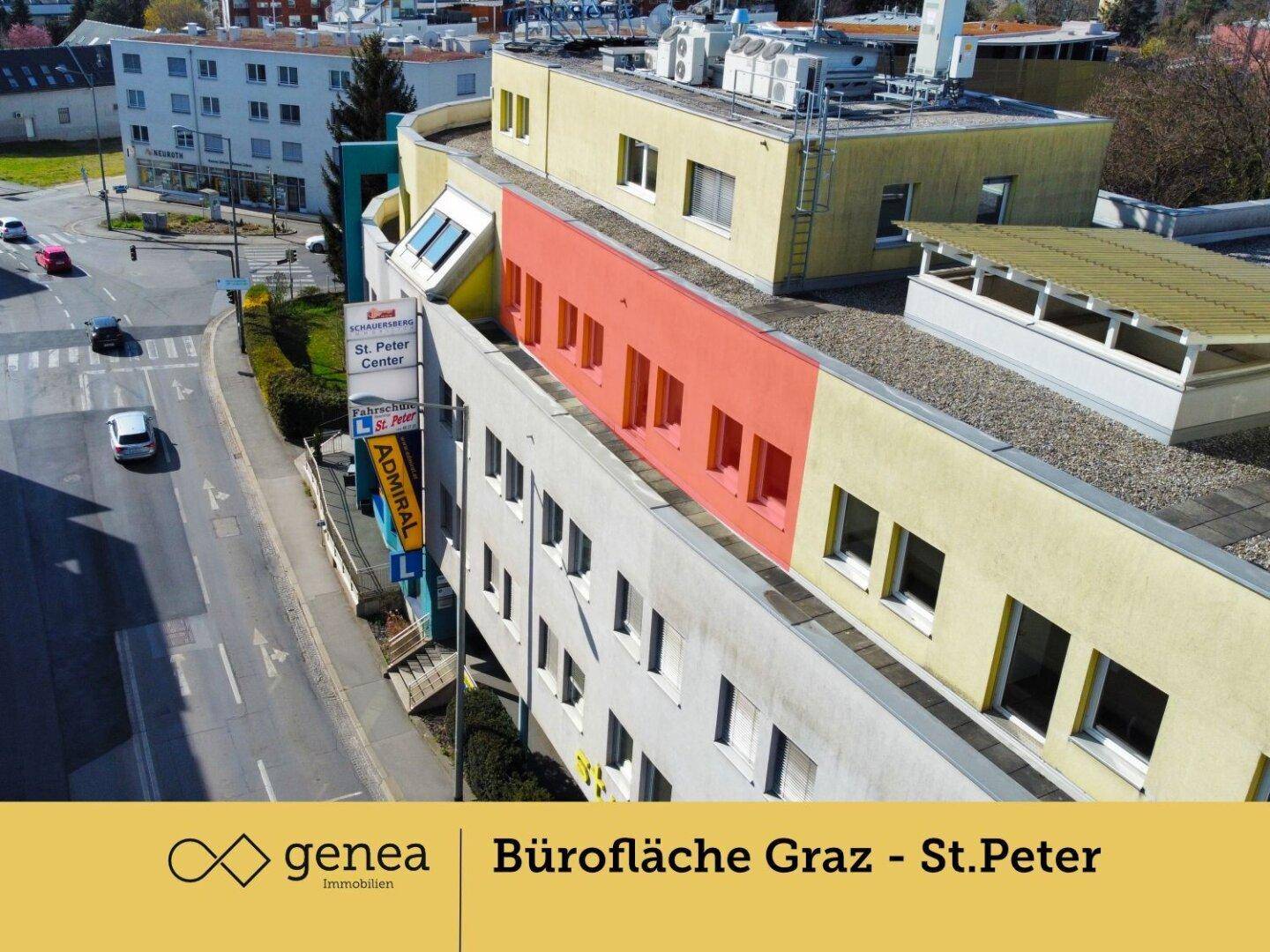 Luftaufnahme des Bürokomplexes mit farbigen Fassadenabschnitten und umliegender Infrastruktur.