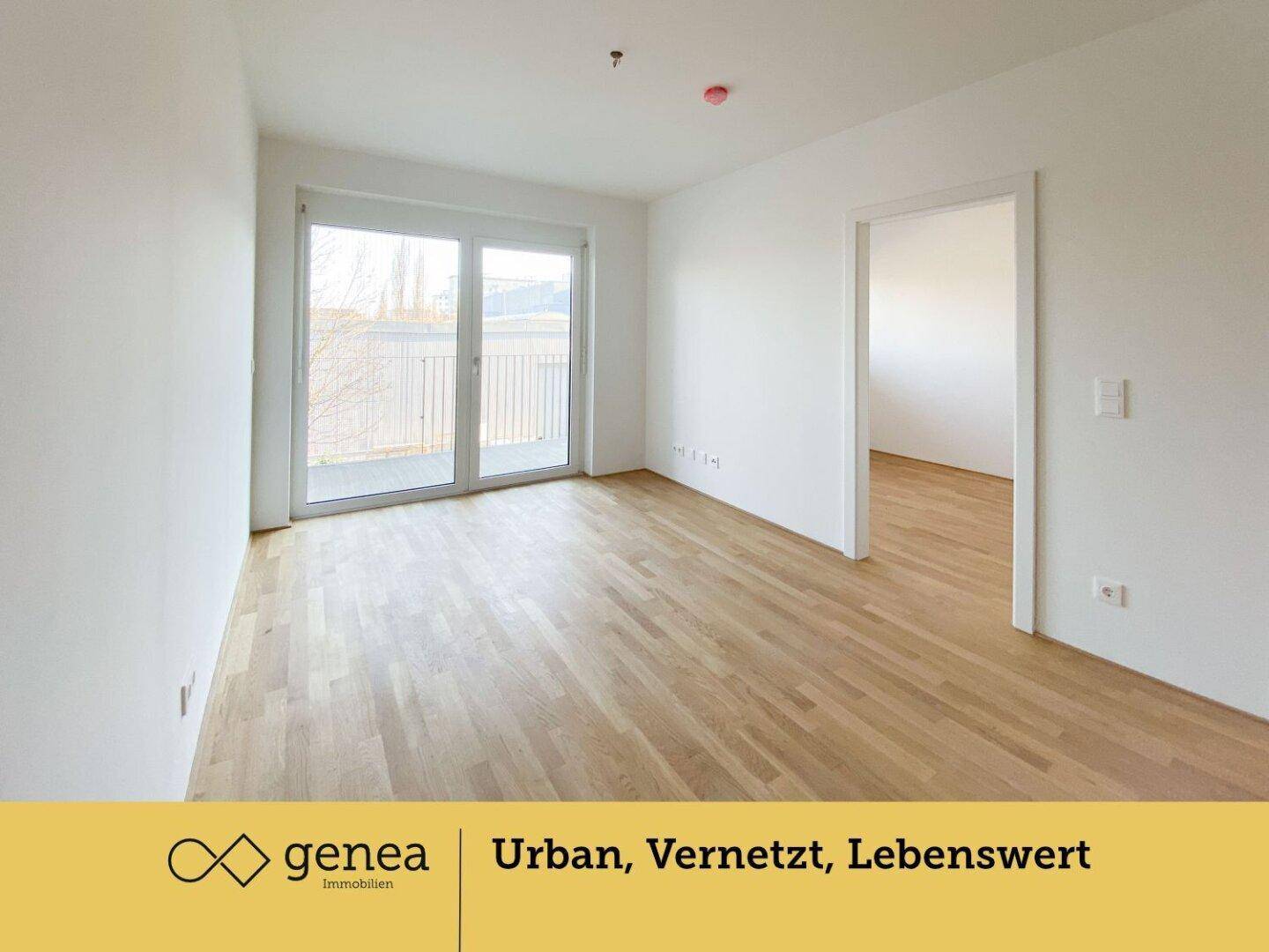 Geräumiges Wohnzimmer mit Parkettboden, großen Fenstern und direktem Zugang zum Balkon.