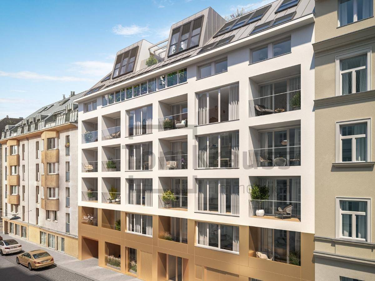 Ansicht der modernen Wohnfassade mit zahlreichen Balkonen und großen Fensterfronten.