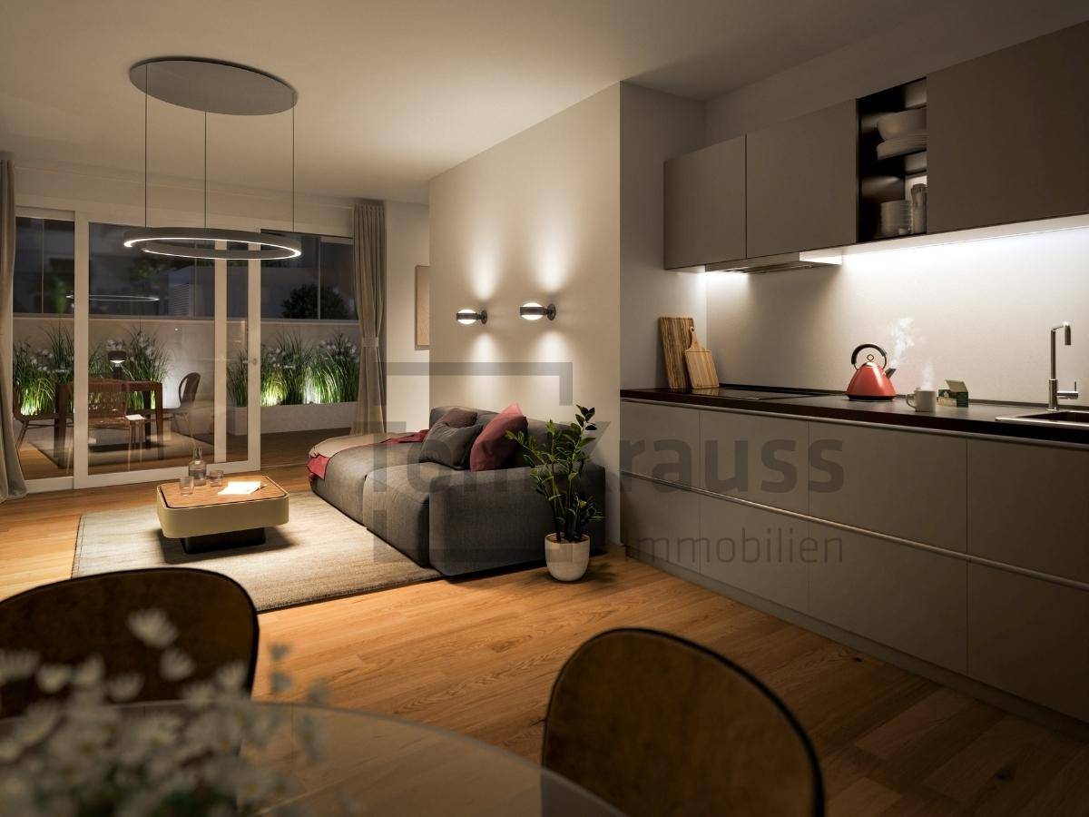 Gemütlicher Wohnbereich mit integrierter Küchenzeile, Holzboden und Zugang zur Terrasse.