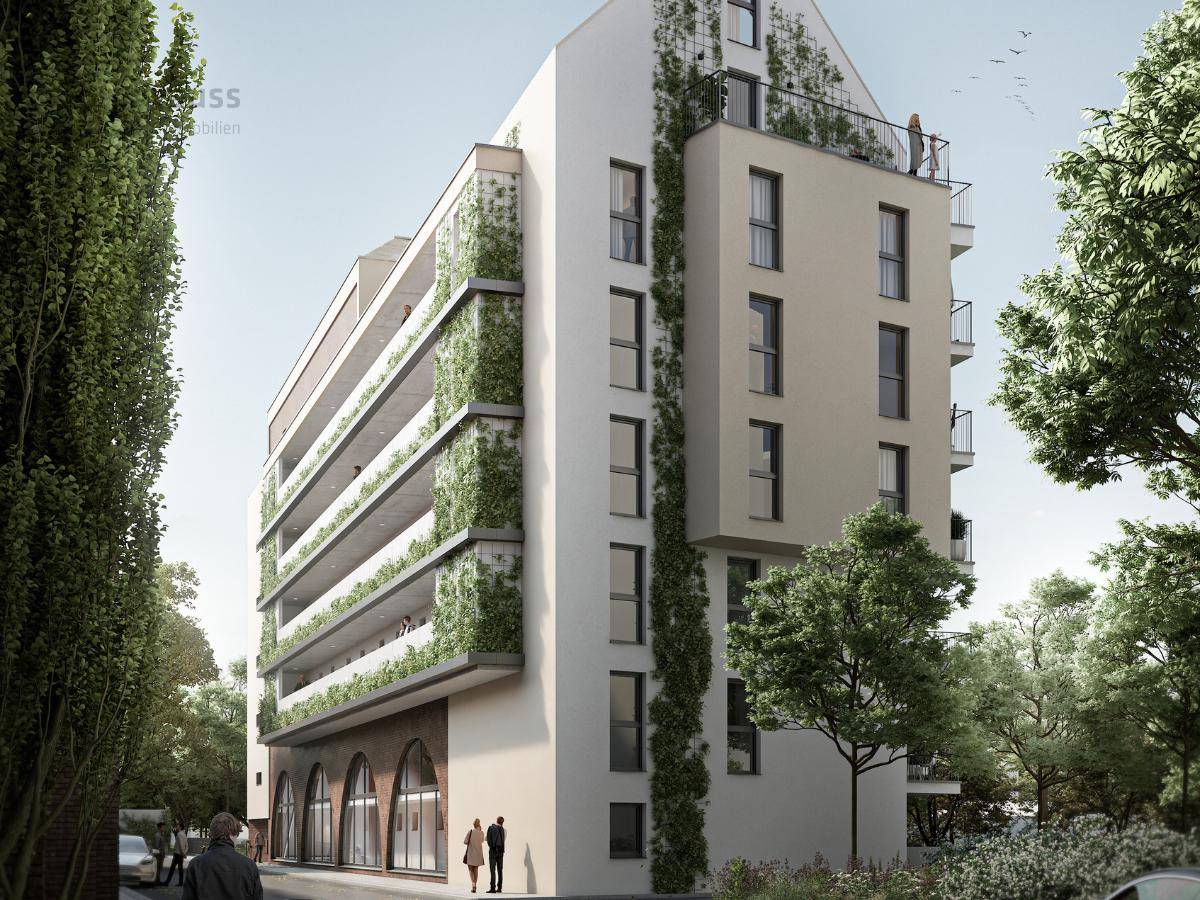 Moderne Gebäudefassade mit vertikaler Begrünung und großen Fenstern an einem sonnigen Tag.