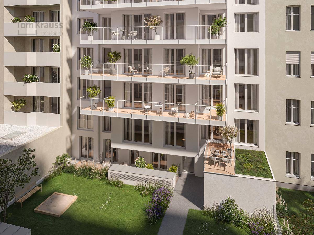 Neubau mit Balkonen und einer gepflegten Gartenanlage im Erdgeschoss.