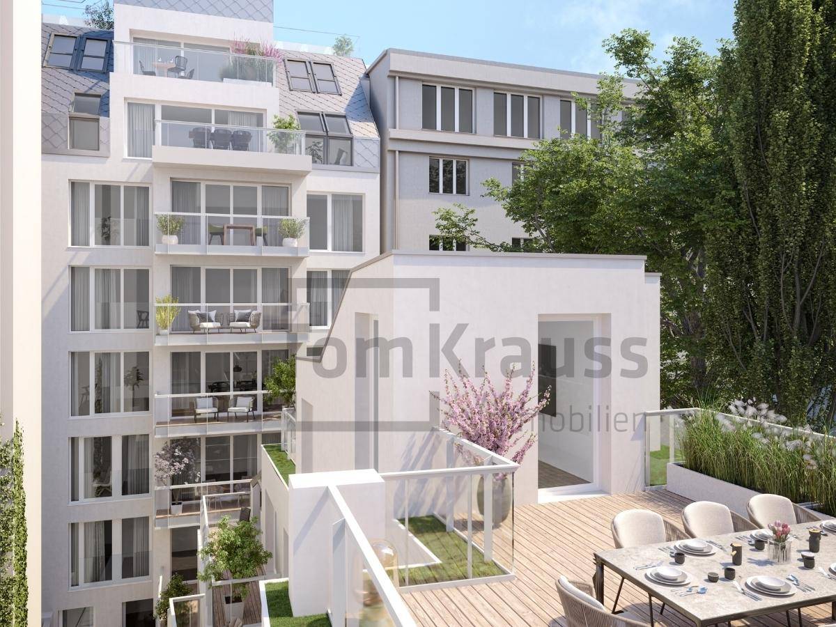 Dachterrasse mit Essbereich und Bepflanzung, umgeben von modernen Wohngebäuden und Grünflächen.