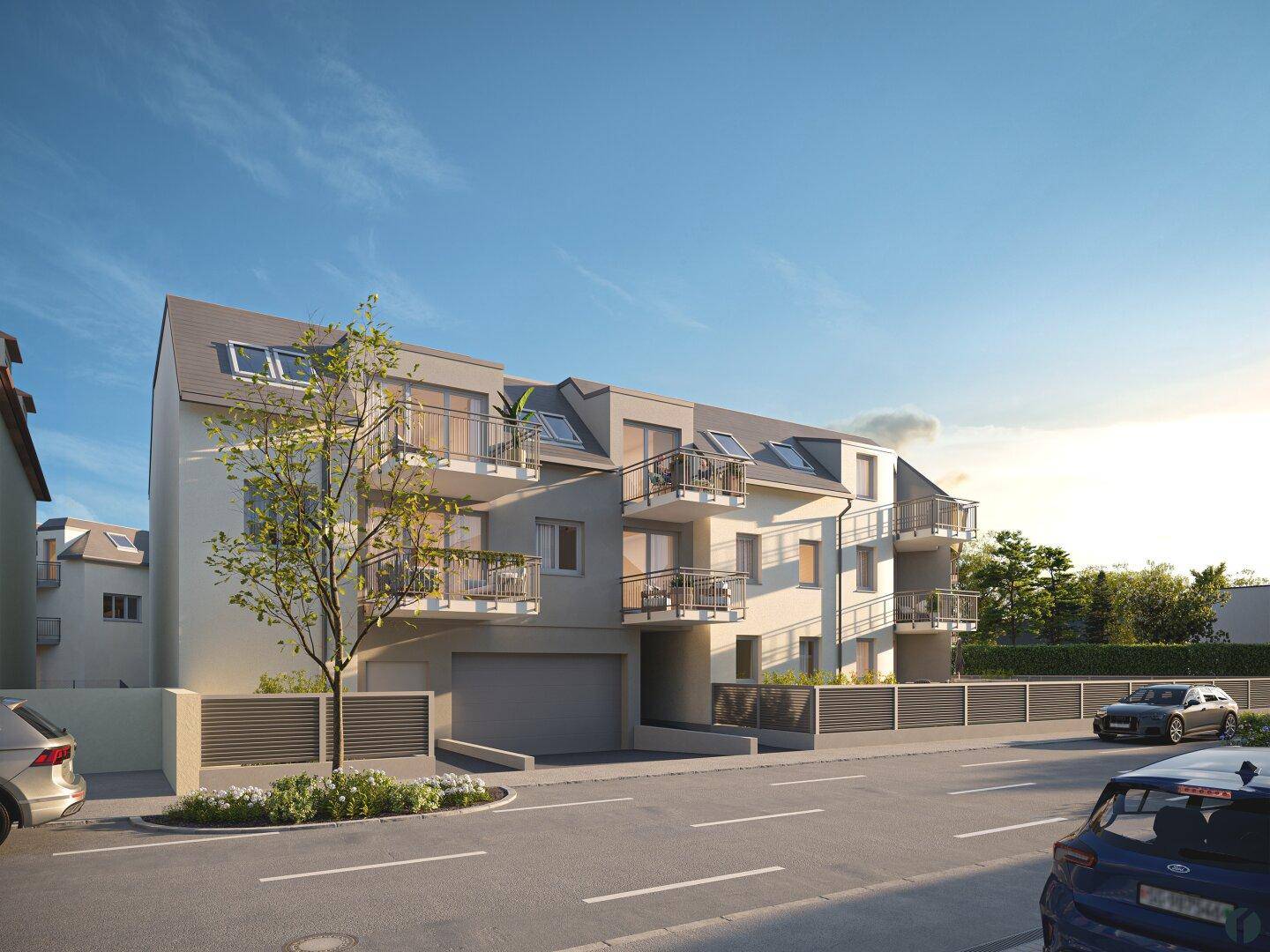 Moderne Wohngebäude mit Balkonen, Dachfenstern und einer Tiefgarageneinfahrt.