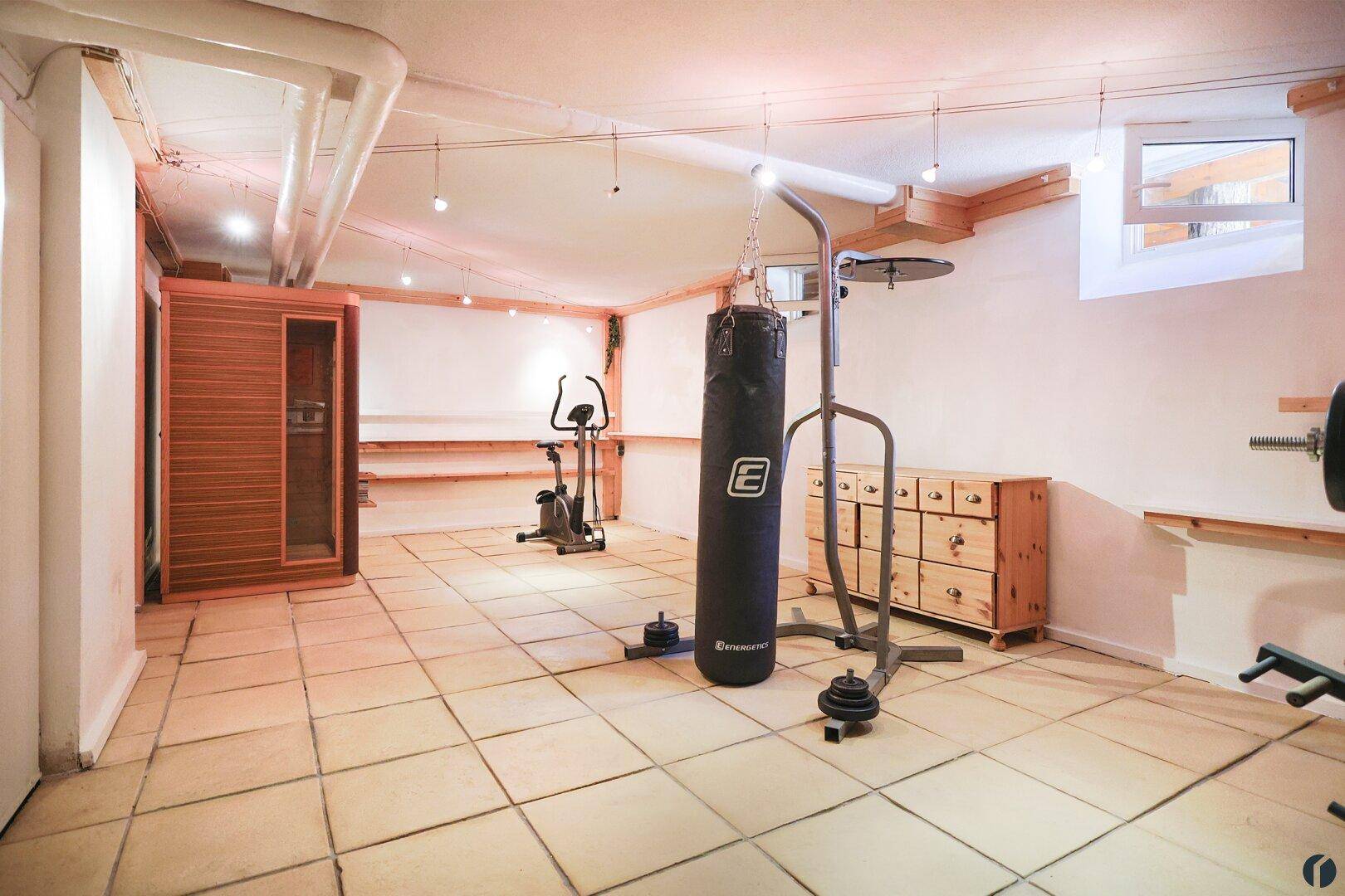 Fitnessraum mit Infrarotkabine im Keller