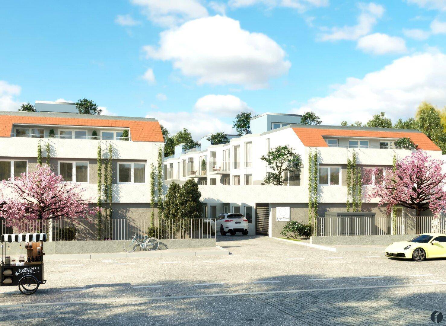 Moderne Wohnanlage mit mehreren Gebäuden, umgeben von blühenden Bäumen und Parkplätzen.