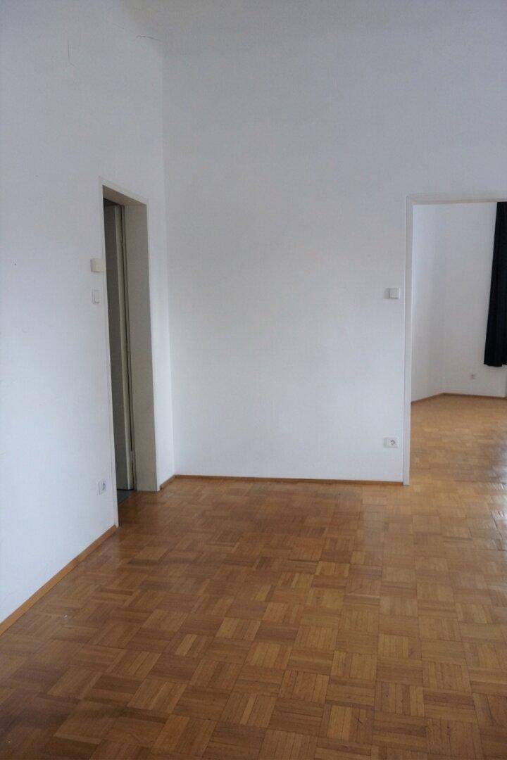 Flur mit klassischem Parkettboden, der verschiedene Räume miteinander verbindet und einladend wirkt.