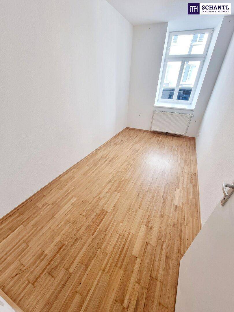 Helles Zimmer mit Parkettboden und Dachfenster, ideal für ein Schlafzimmer.