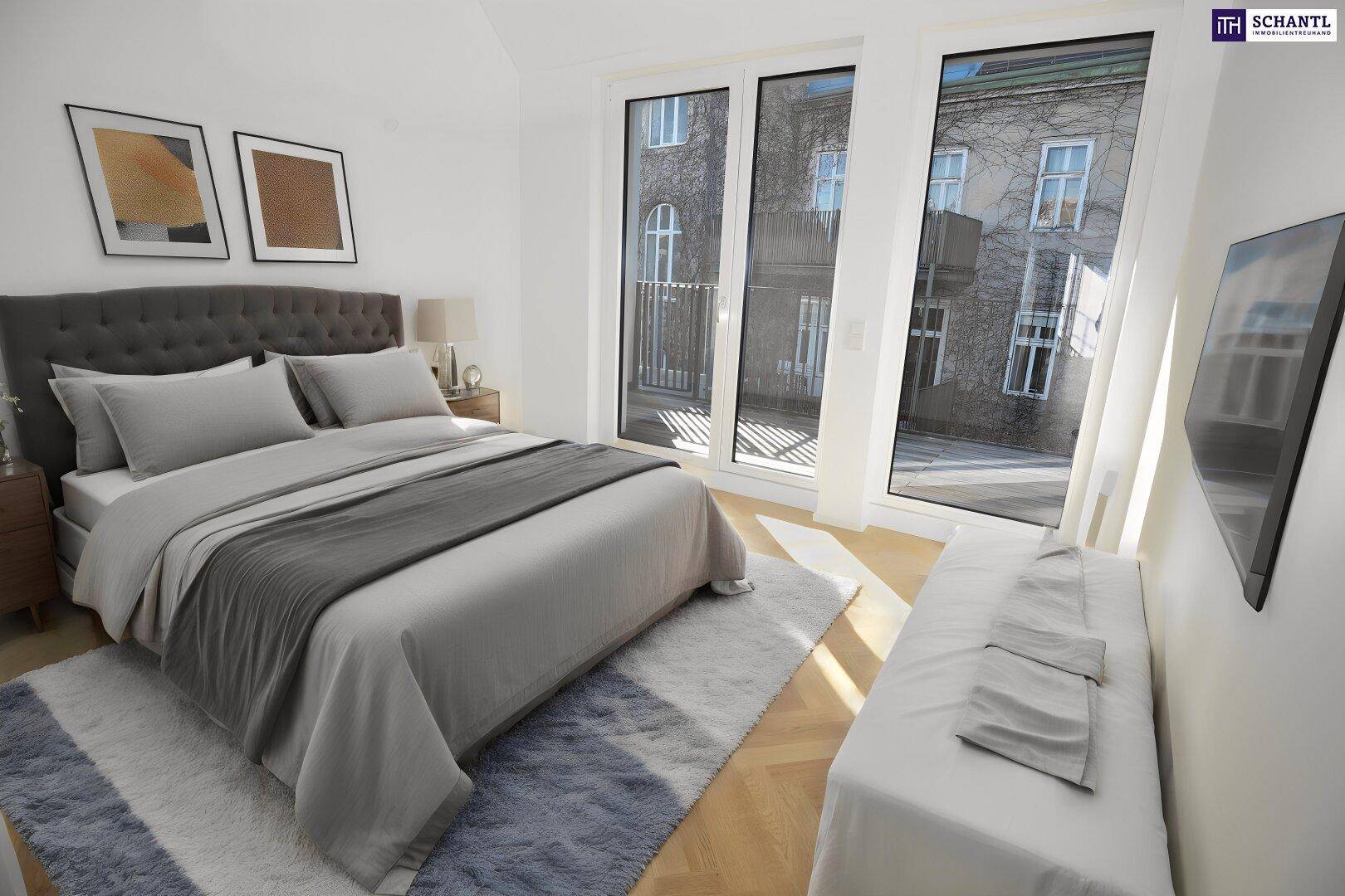 Gemütliches Schlafzimmer mit großem Bett, Parkettboden und Zugang zu einem französischen Balkon.