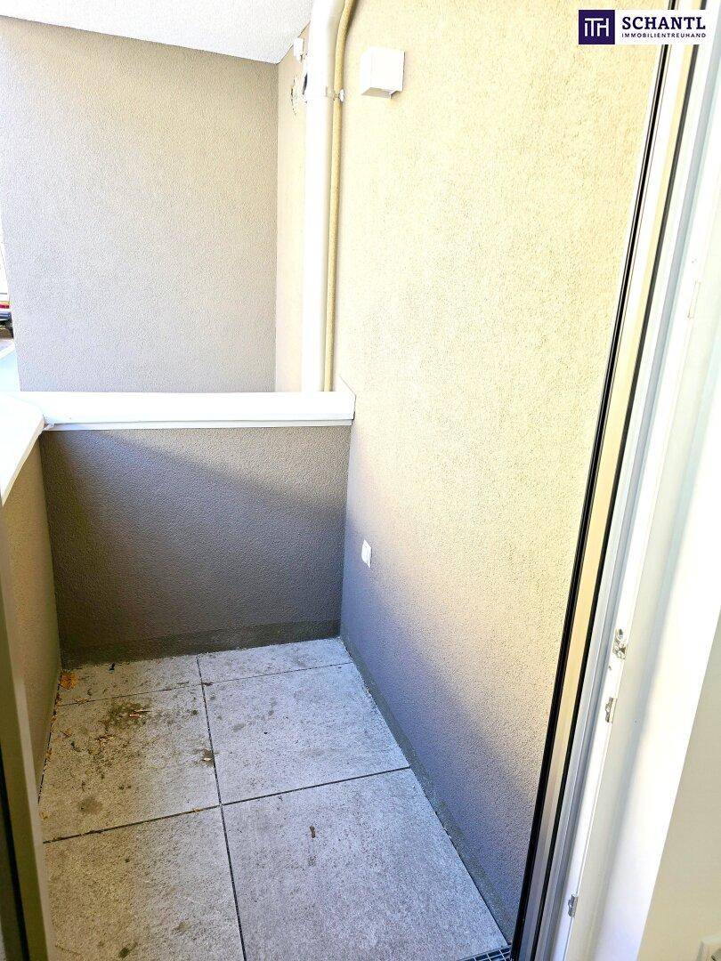 Kleiner, gefliester Balkon mit beigen Wänden, ideal für eine gemütliche Sitzecke im Freien.