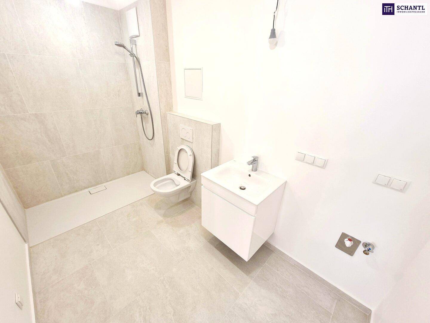 Modernes Badezimmer mit Duschbereich, wandhängendem WC und Waschtisch.