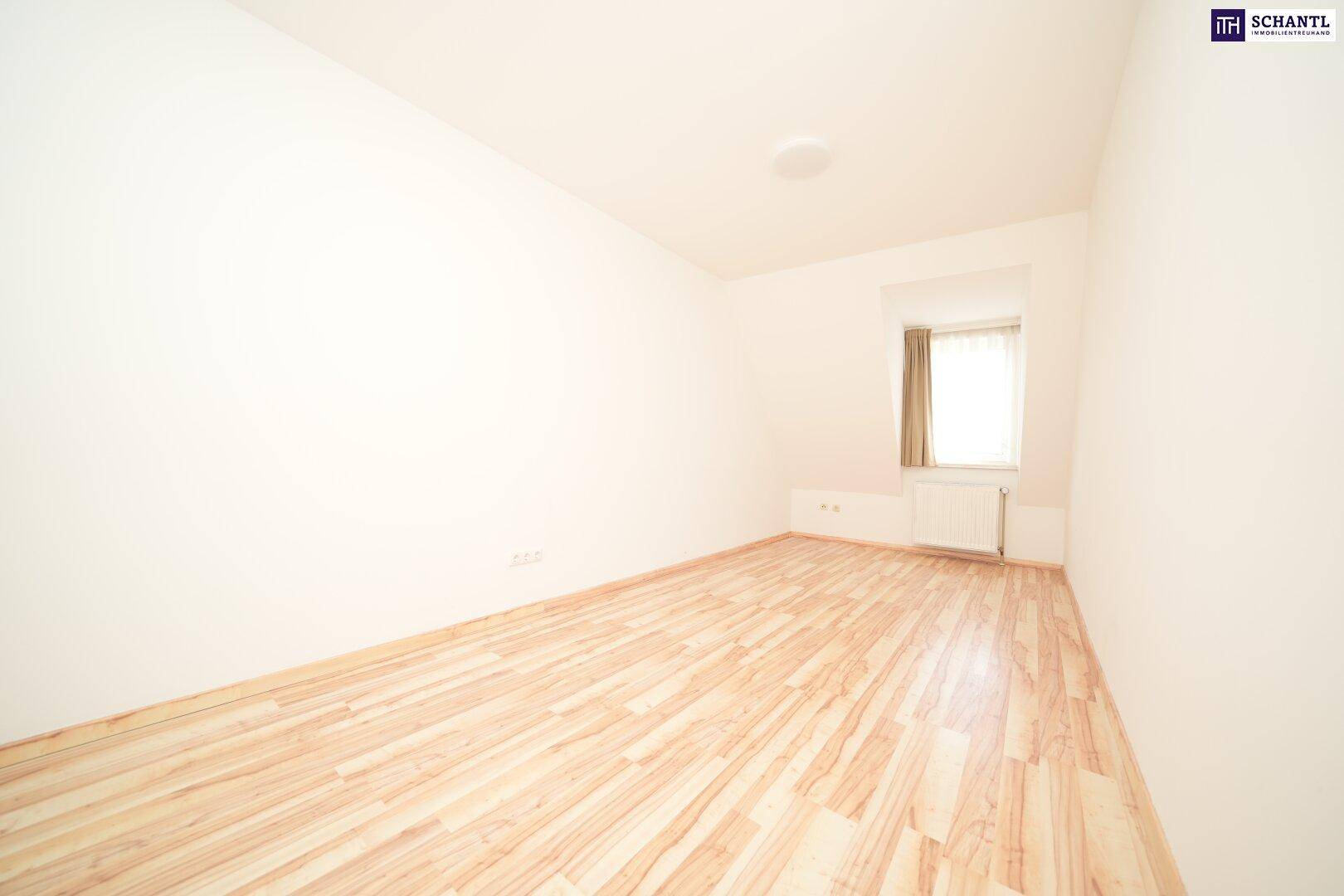 Helles Zimmer mit Laminatboden und Fenster, ideal als Schlaf- oder Kinderzimmer, bietet eine angenehme Atmosphäre.