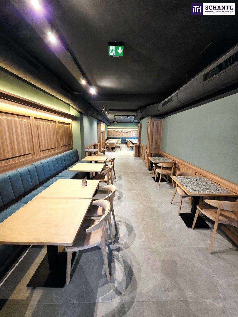 Langer Gastraum mit Sitzbänken, Holztischen und Fliesenboden, ideal für Veranstaltungen.