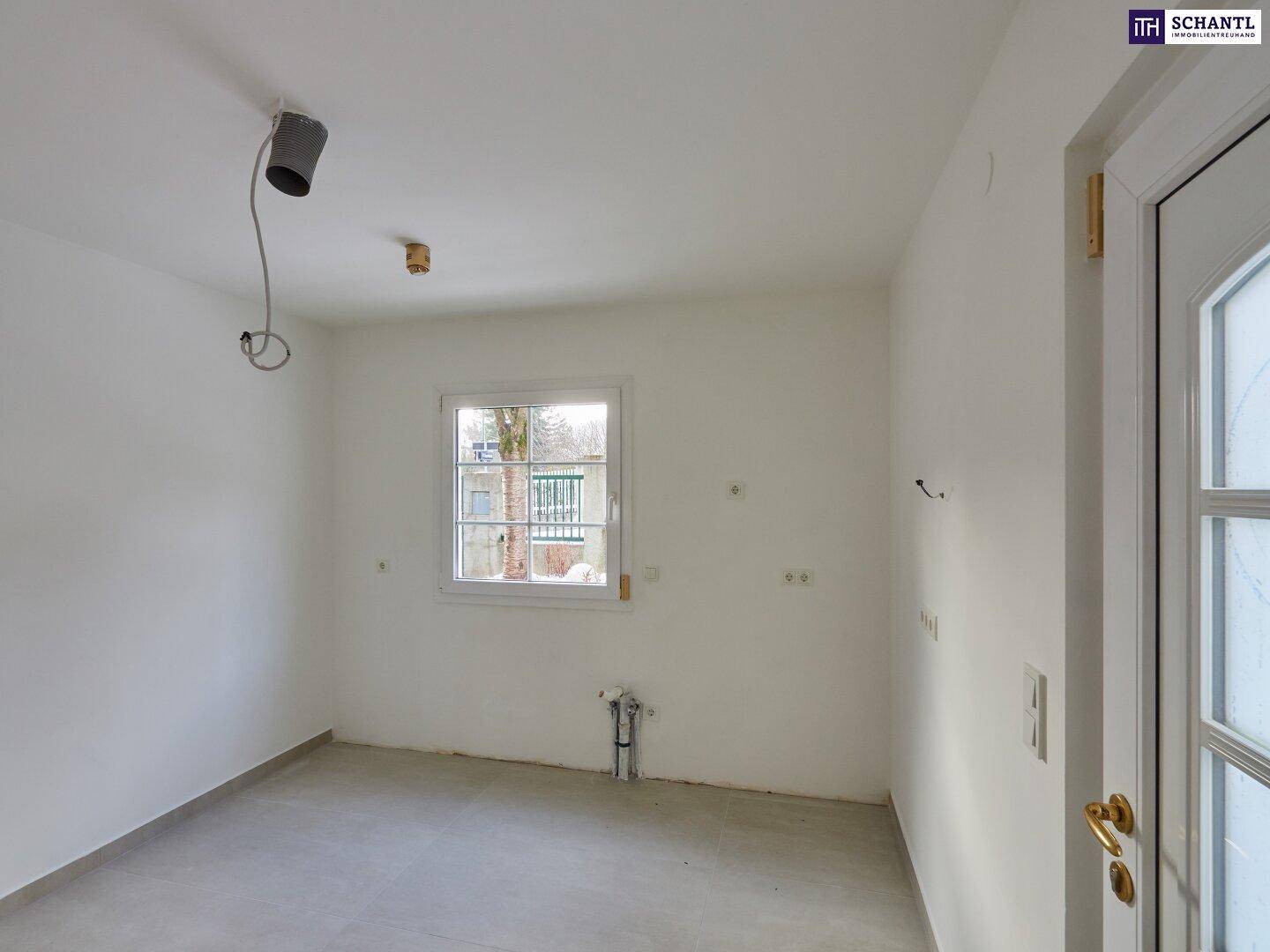 Unmöblierter Raum mit Fenster und Fliesenboden, ideal als zukünftige Küche oder Abstellraum.