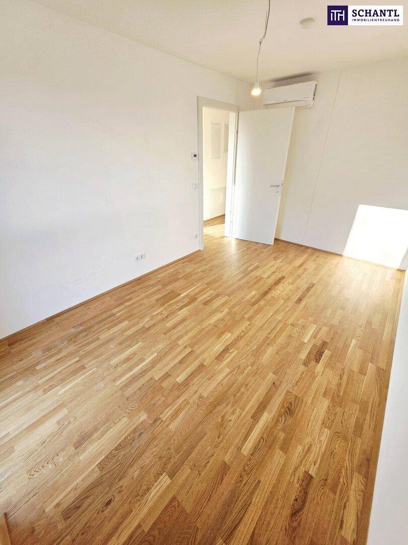 Freundliches Zimmer mit Holzboden und Klimaanlage, ideal als Schlaf- oder Gästezimmer.