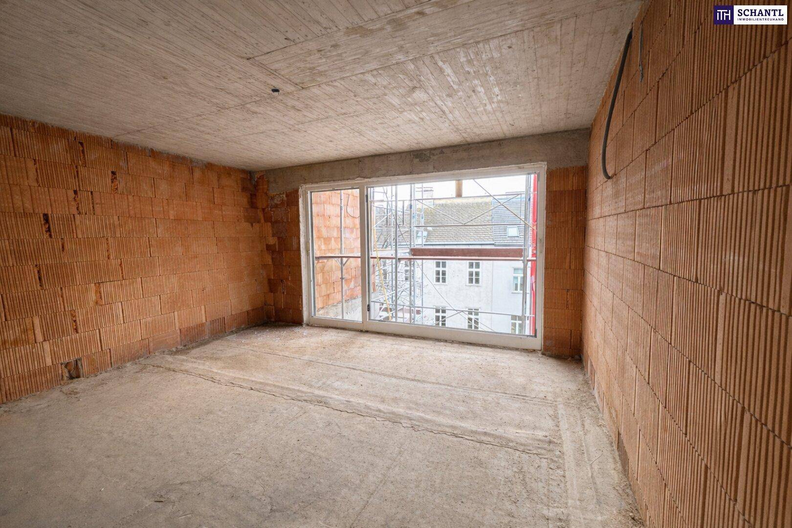 Rohbau eines Raumes mit unverputzten Ziegelwänden und Betonboden, bereit für den Ausbau.