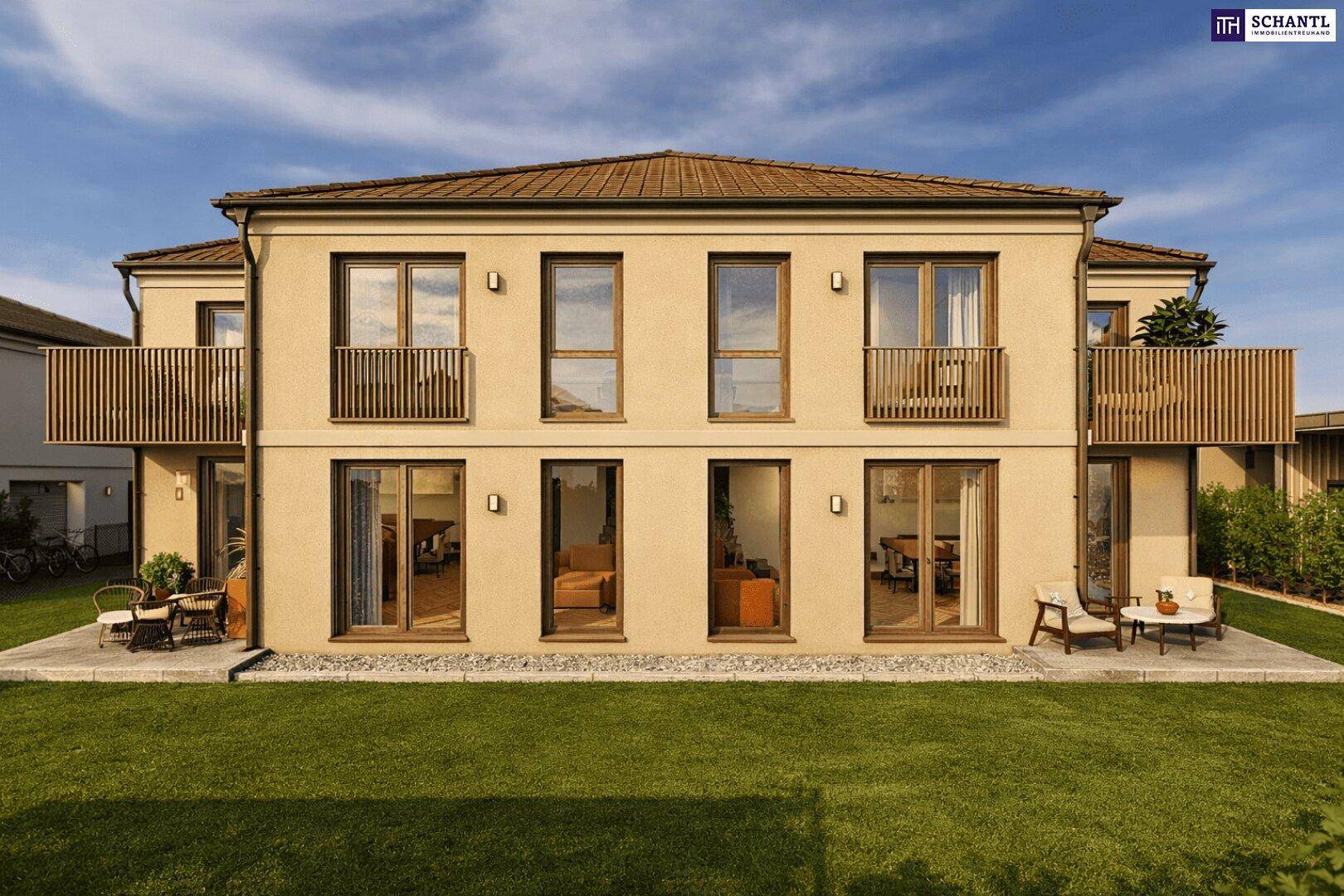 Vorderansicht der Doppelhaushälfte mit Balkonen, Terrasse und gepflegtem Rasenbereich.