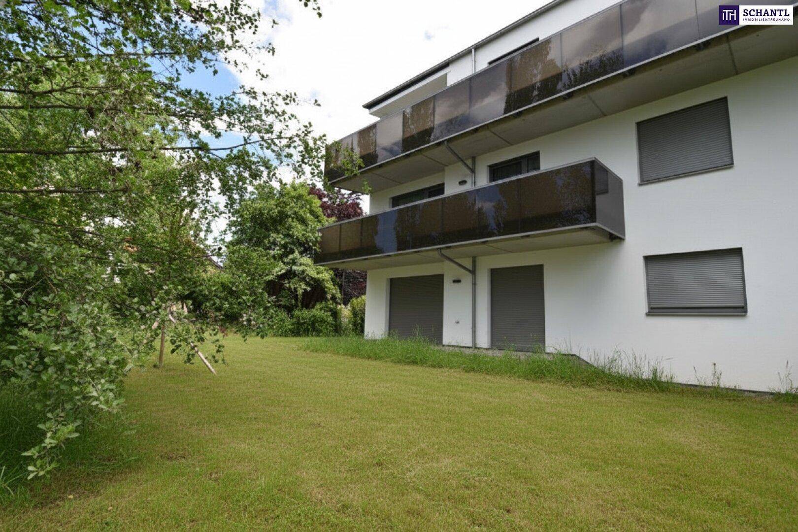 Mehrfamilienhaus mit mehreren Balkonen und einer ungepflegten Rasenfläche im Vordergrund.