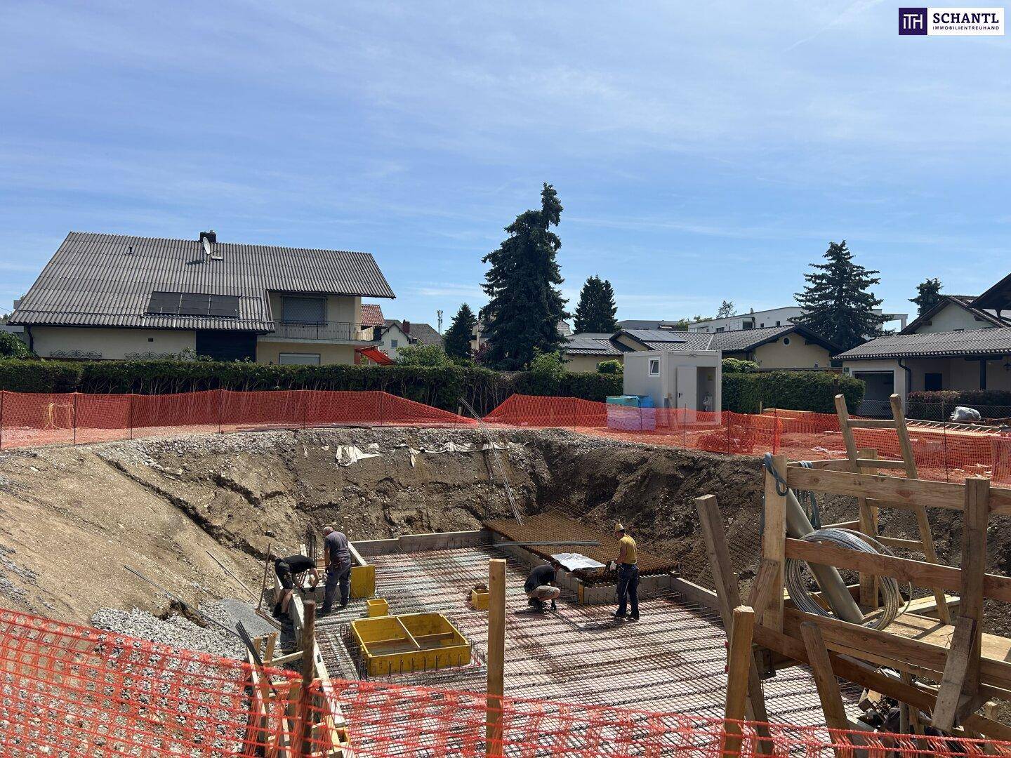 Baugrube mit Arbeitern bei der Vorbereitung des Fundaments für ein neues Gebäude.