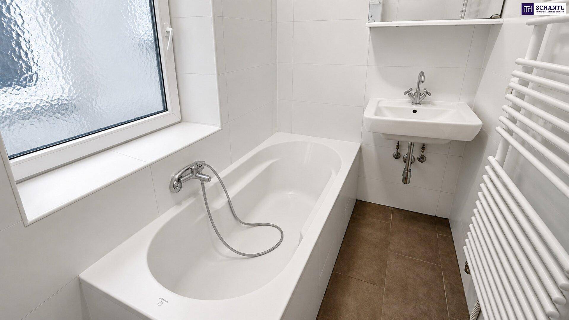 Modernes Badezimmer mit Badewanne, Einzelwaschbecken, beheiztem Handtuchhalter und Fenster.
