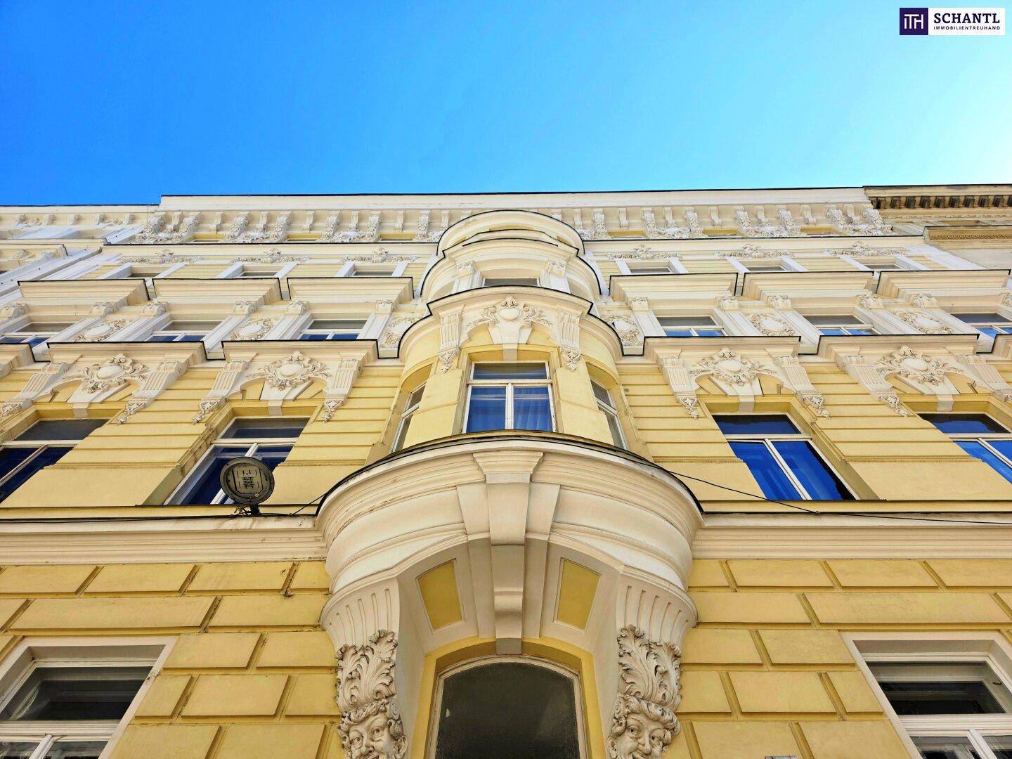 Historische Fassade eines Altbaus mit reich verzierten Stuckelementen und Erker.