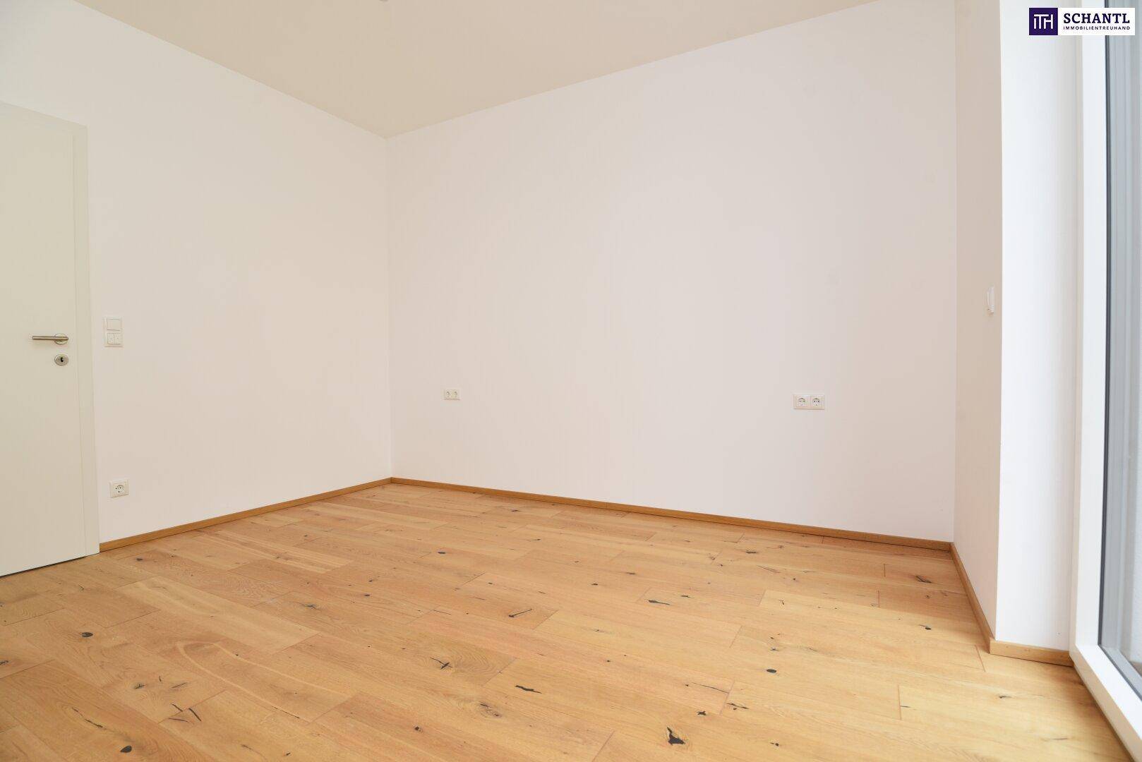 Geräumiges Zimmer mit Holzboden und viel Tageslicht, ideal als Schlaf- oder Arbeitszimmer.